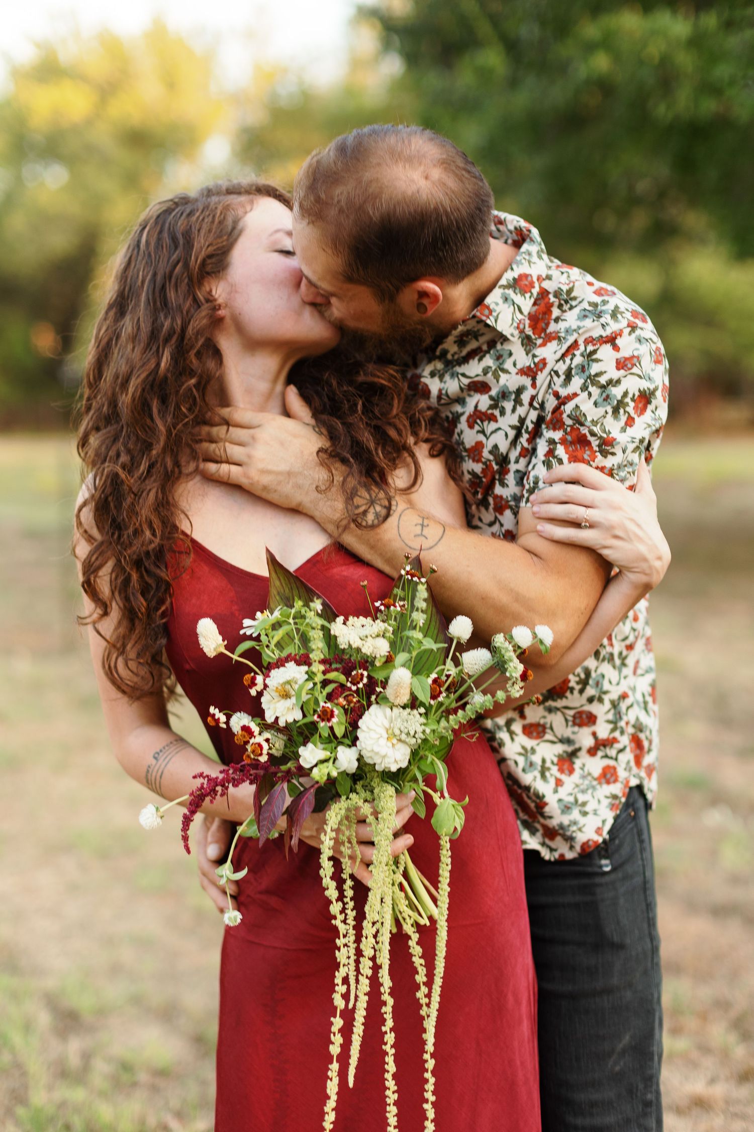Engaged couple kisses for a candid portrait by Emily Joy Photography, now a wedding photographer in Memphis, TN.
