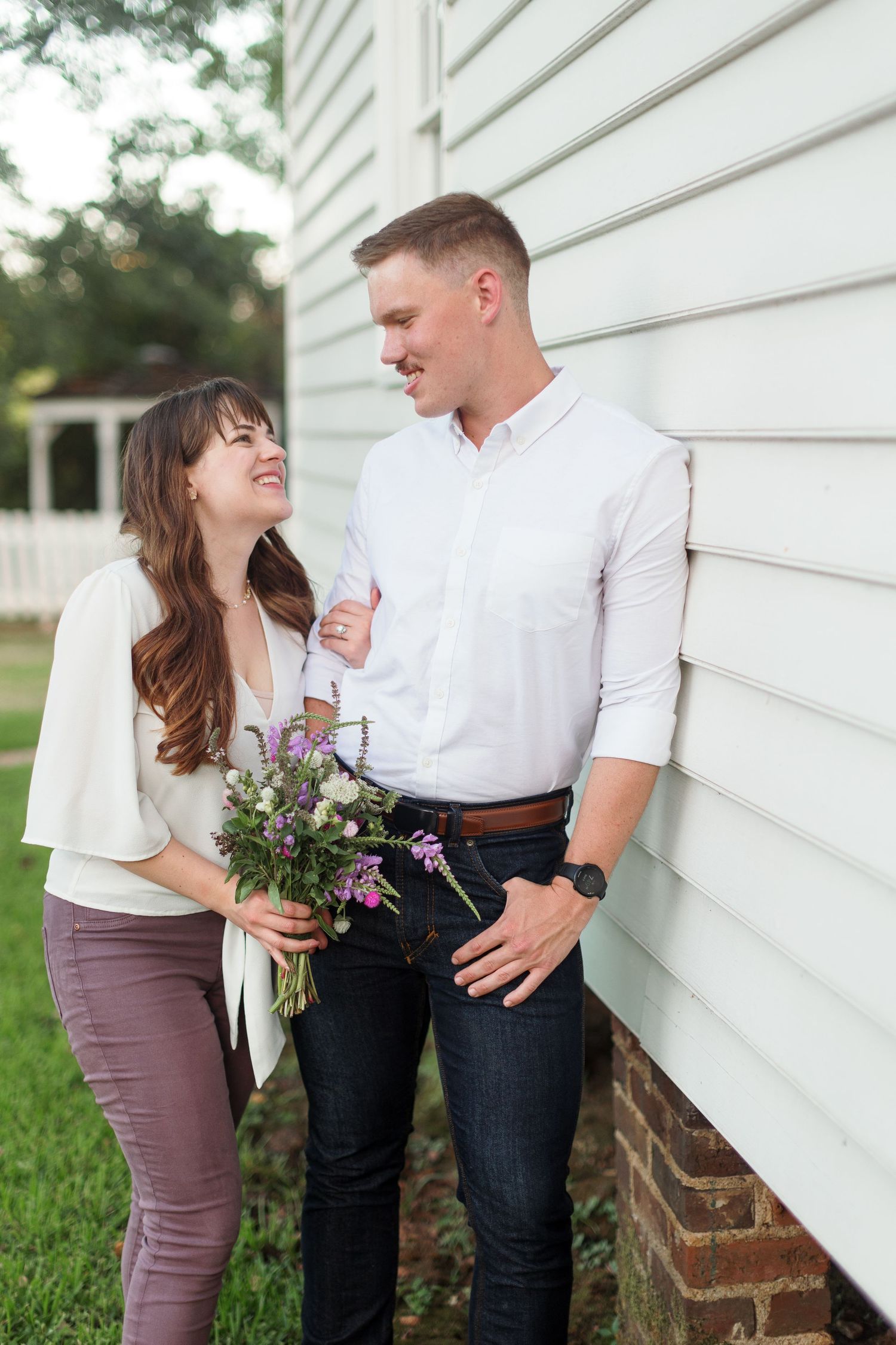Engaged couple cuddles for a portrait by Emily Joy Photography, now a wedding photographer in Memphis, TN.