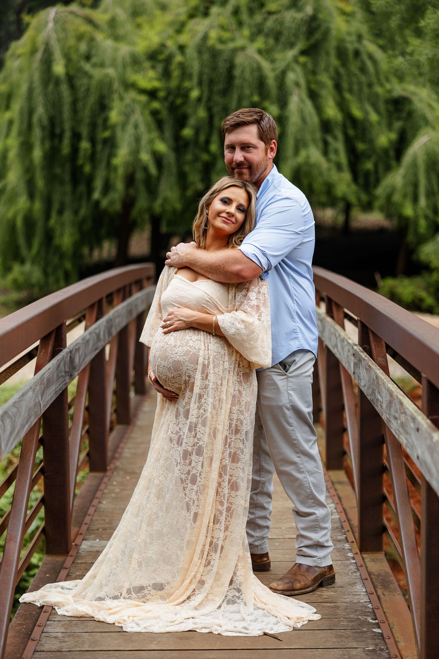 Husband hugs his expectant wife for a portrait by Memphis photographer Emily Joy Photography