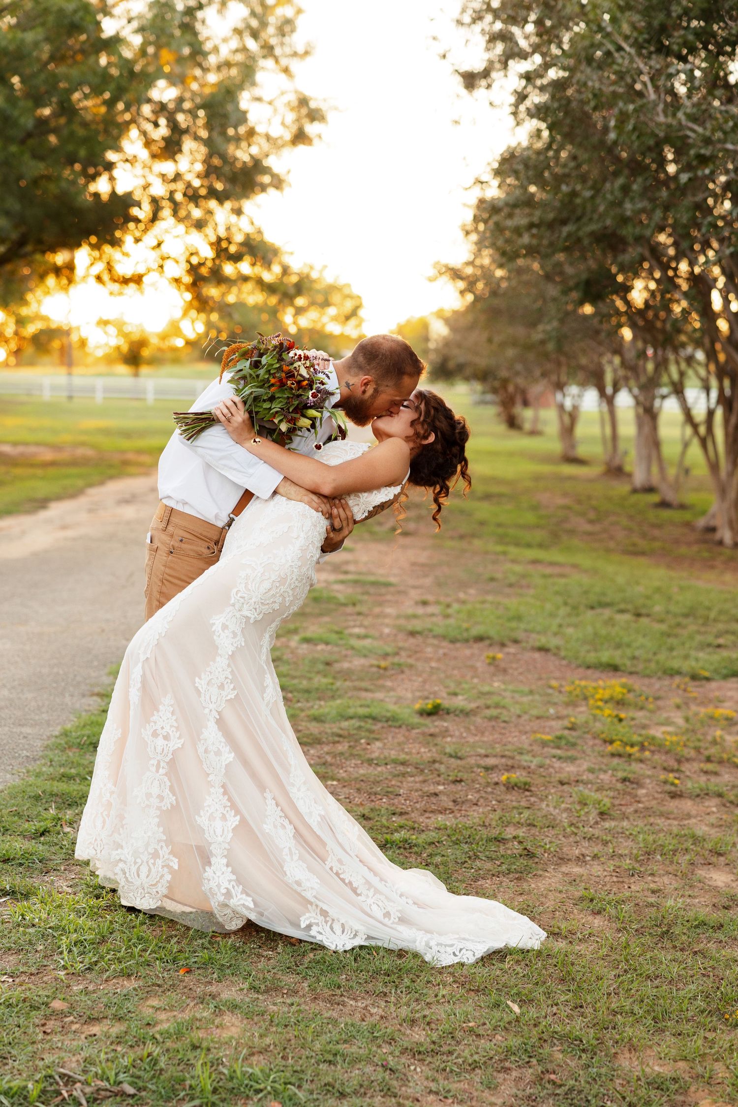 Groom dips his bride for a kiss during sunset for a portrait by Emily Joy Photography, now a wedding photographer in Memphis, TN.