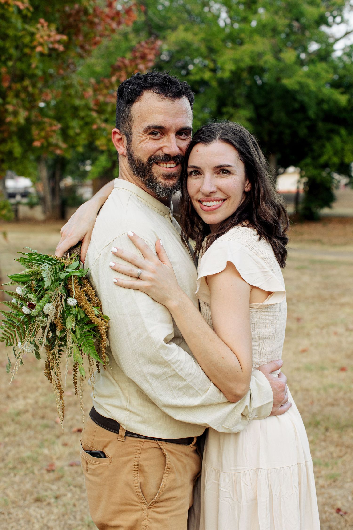 A classy young couple hug for a portrait  by Emily Joy Photography, now a wedding photographer in Memphis, TN.