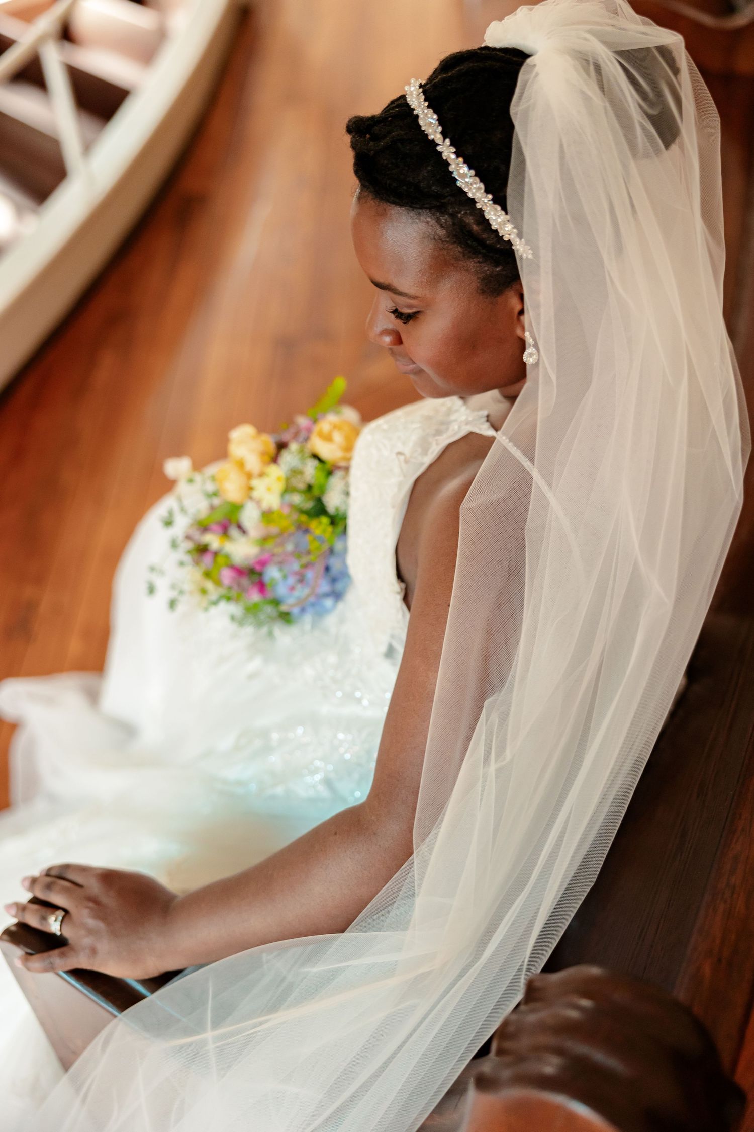 A bride in an elegant gown sits in a Victorian chapel for portrait by Memphis Wedding Photographer Emily Joy Photography