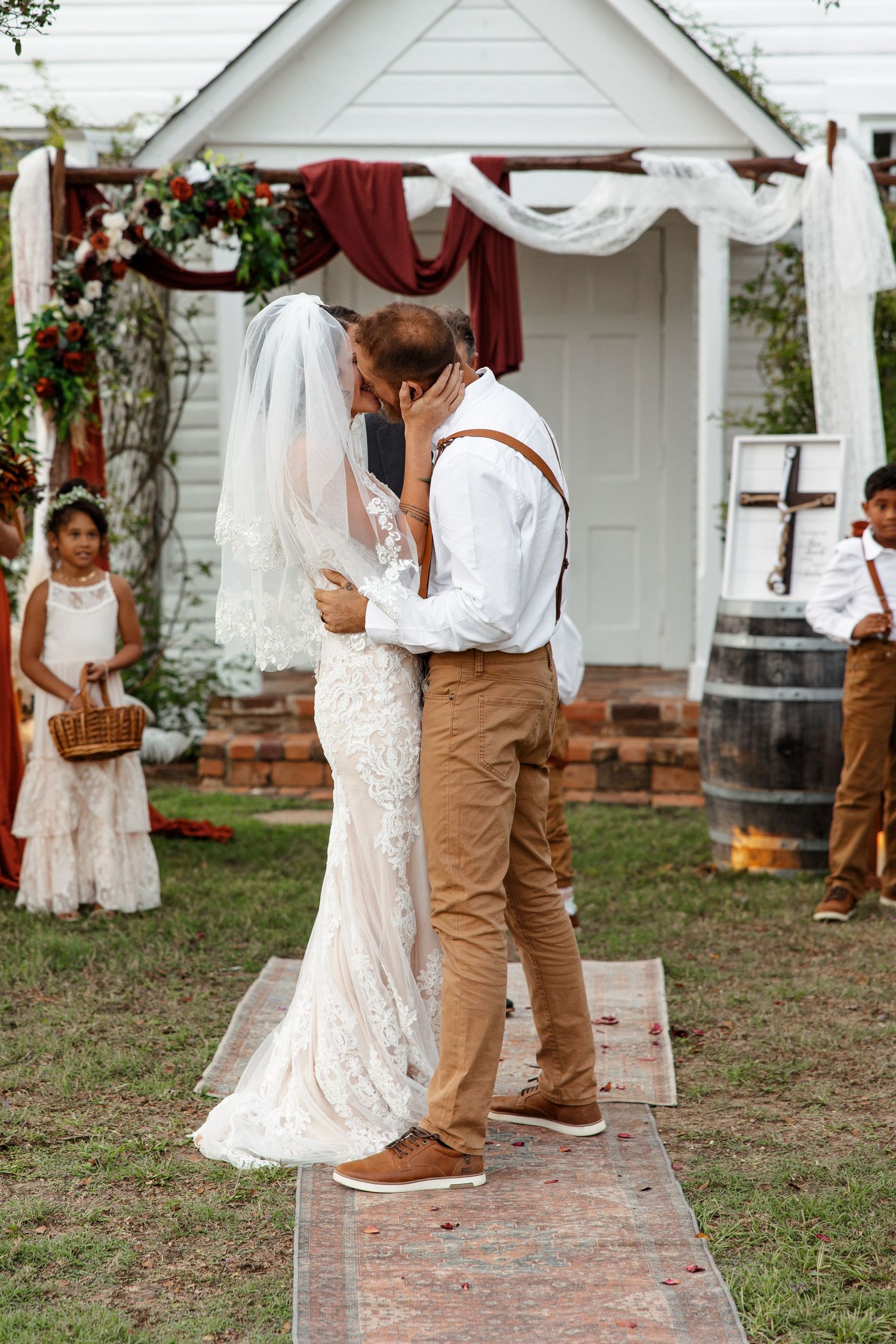 Husband and wife kiss during outdoor wedding photographed by Emily Joy Photography, now a wedding photographer in Memphis, TN.