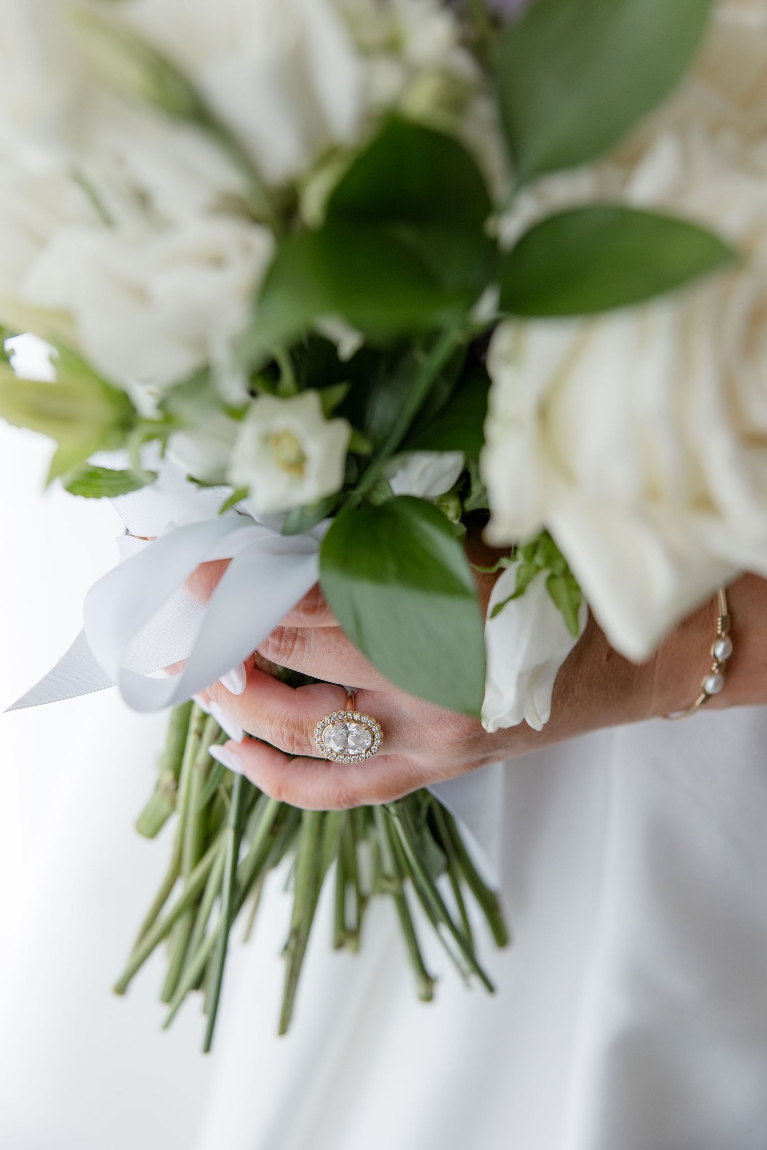 A detail shot of a bride's engagement ring and bouquet in a portrait by Emily Joy Photography, wedding photographer in Memphis, TN.