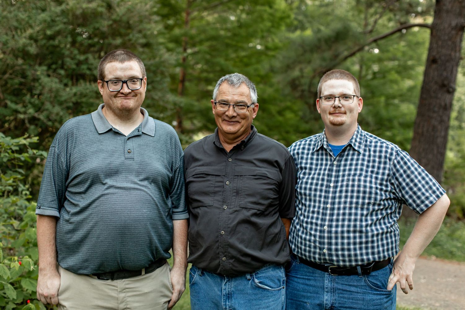 Father with two grown sons smile for a portrait by Emily Joy Photography, now a wedding photographer in Memphis, TN.