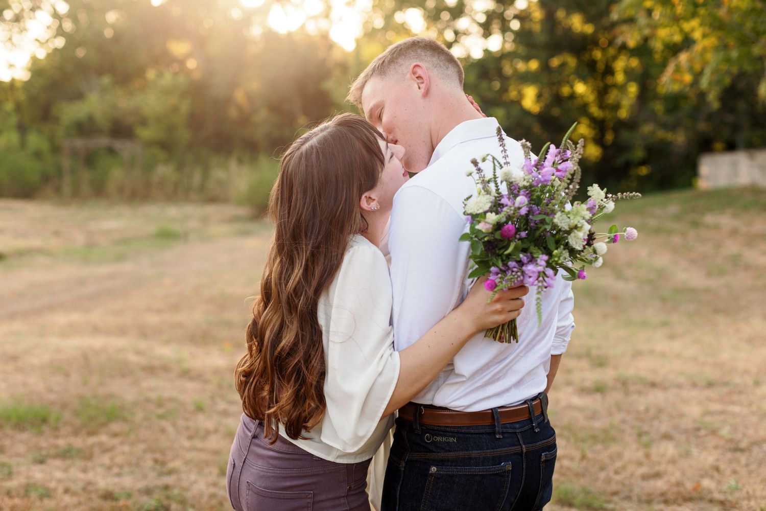 Engaged couple laughs as they are about to kiss for a portrait by Emily Joy Photography, now a wedding photographer in Memphis, TN.