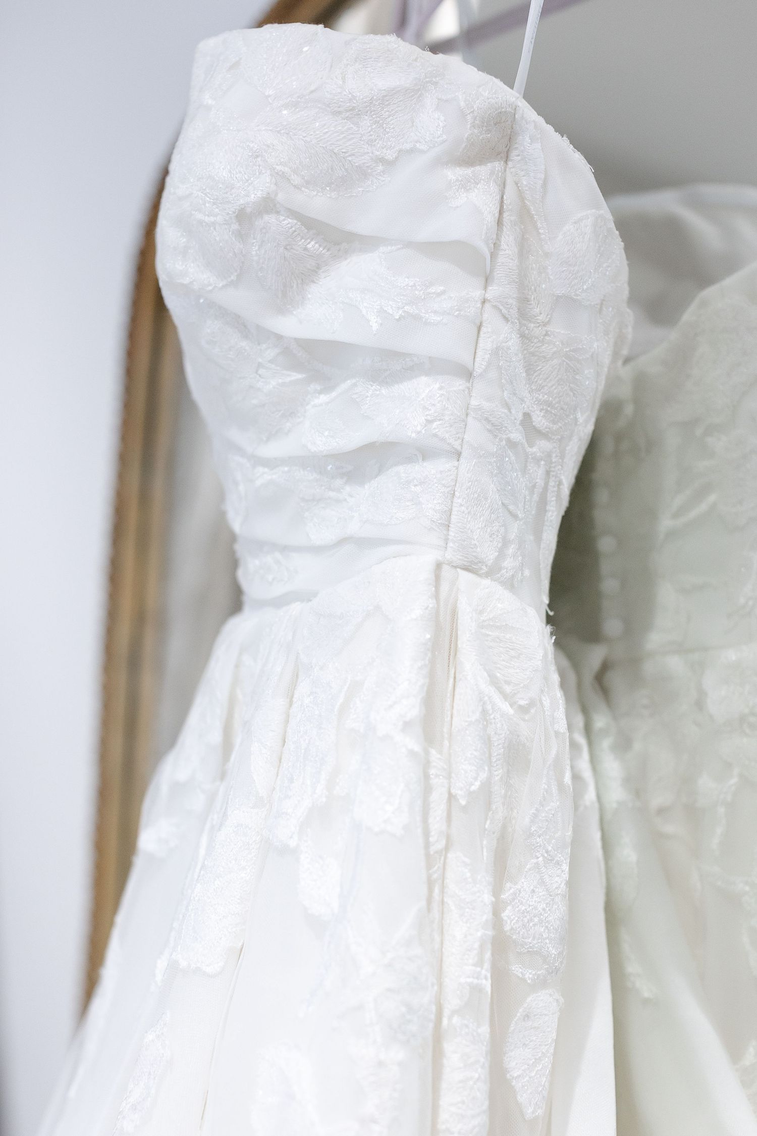 A white wedding gown bodice, covered in lace. Image by Emily Joy, wedding photographer in Memphis.