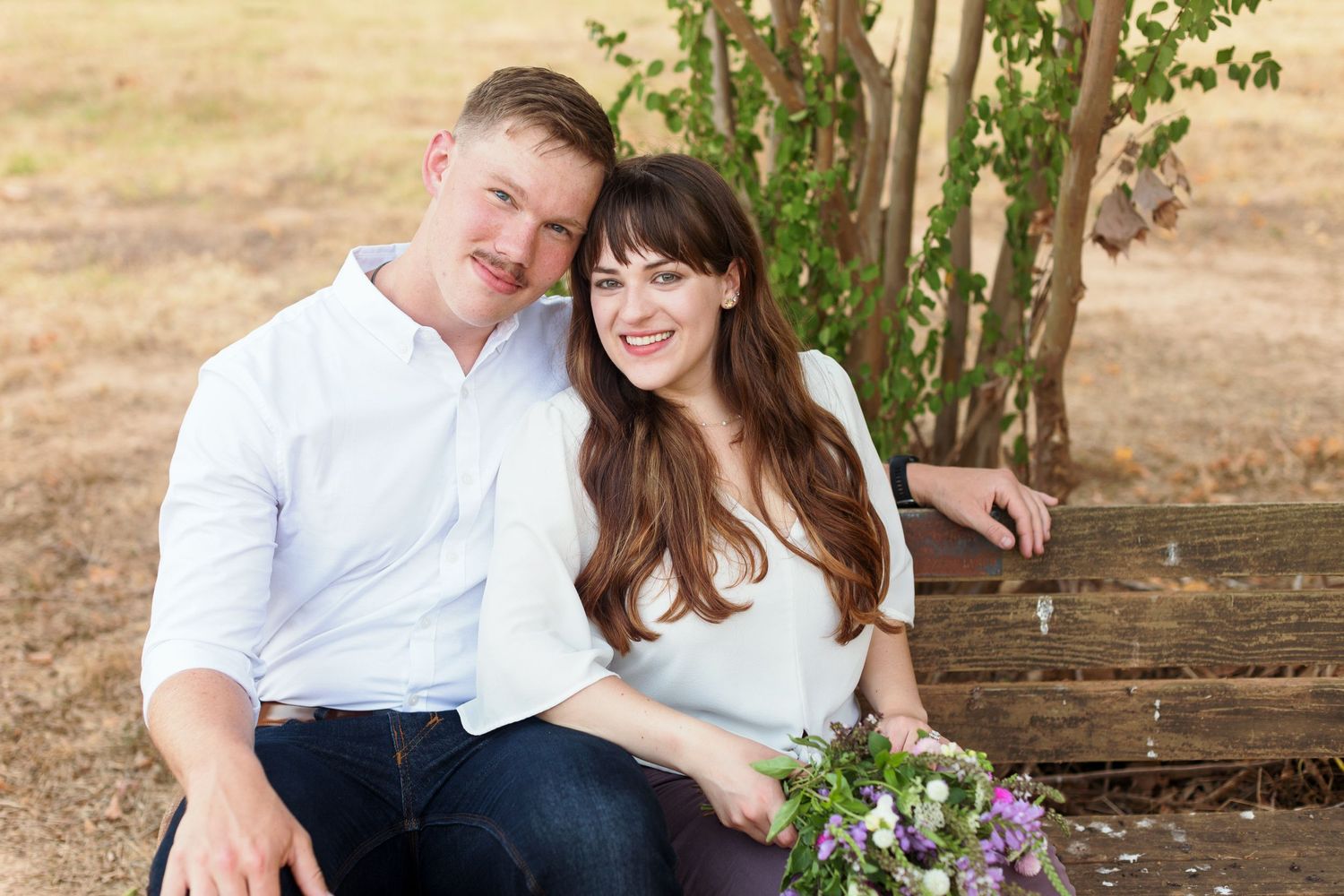 Engaged couple smiles at the camera for a portrait by Emily Joy Photography, now a wedding photographer in Memphis, TN.