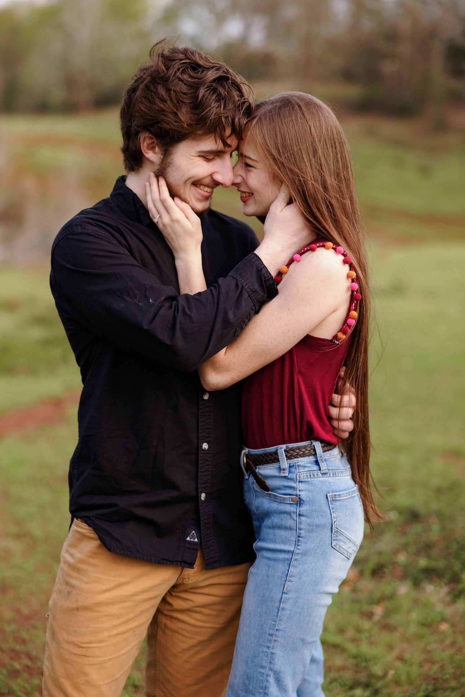 Young couple hugs and smiles at each other for a portrait by Memphis wedding photographer Emily Joy Photography