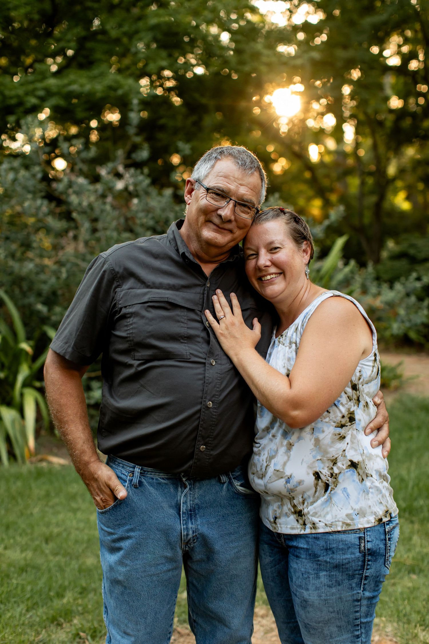 A husband and wife smile for a portrait by Emily Joy Photography, now a wedding photographer in Memphis, TN.