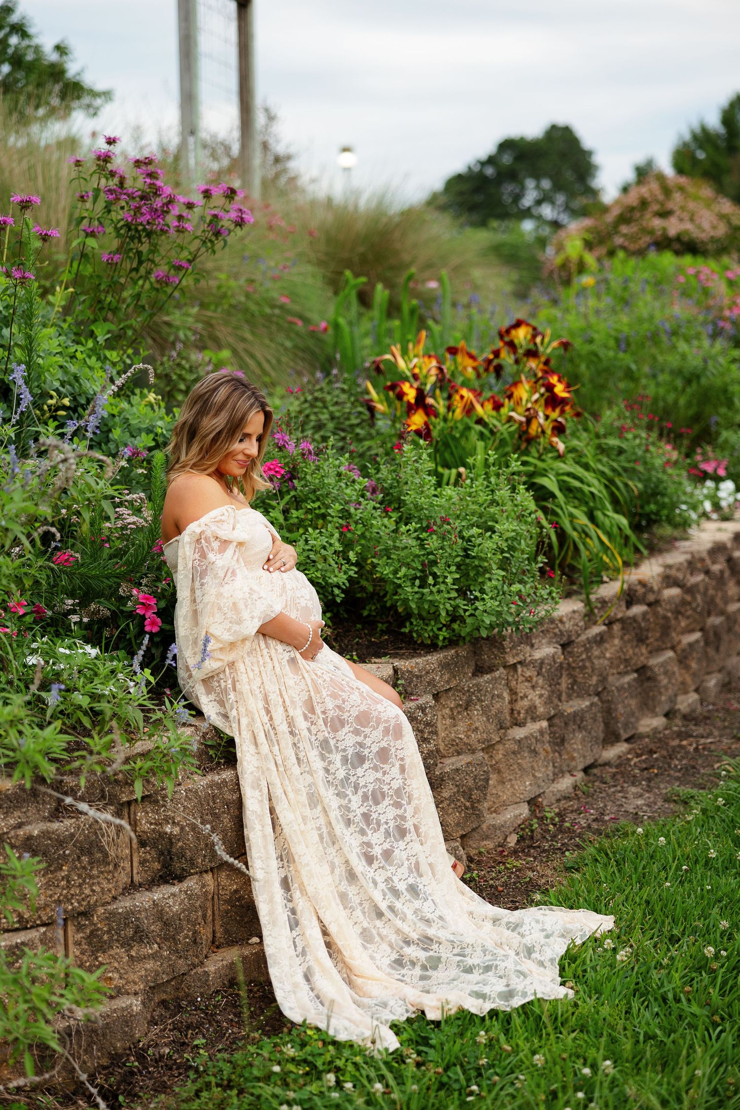 Expectant mother smiles down at her baby bump for a portrait by Memphis photographer Emily Joy Photography