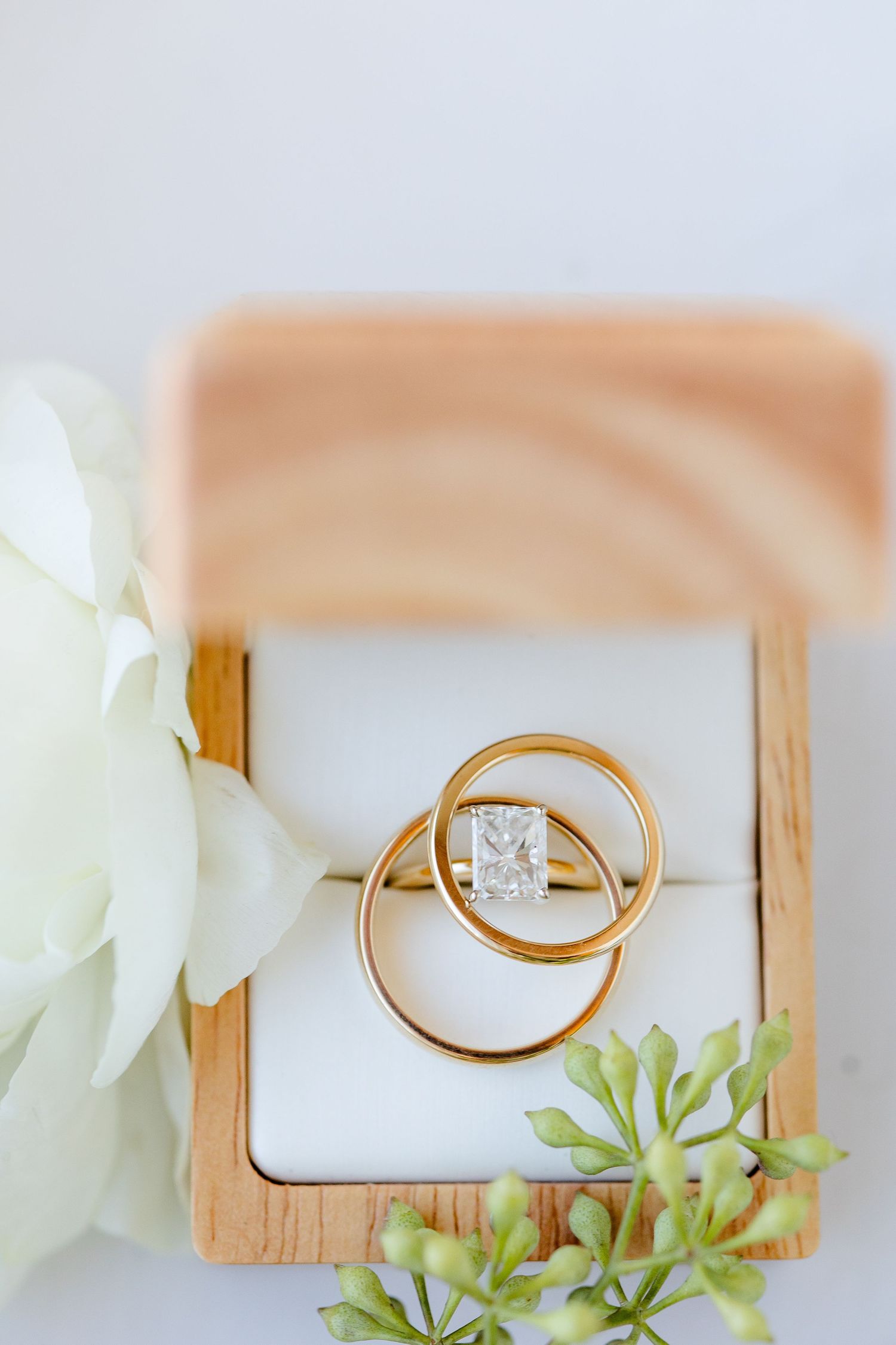 A macro detail shot of the bride's engagment ring framed by his and her wedding bands. Image by Emily Joy, wedding photographer in Memphis.