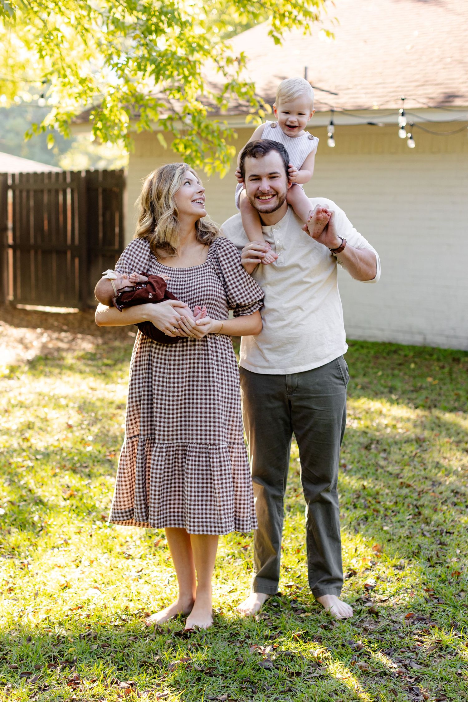 Young family smiling at each other for a portrait by Memphis wedding photographer Emily Joy Photography