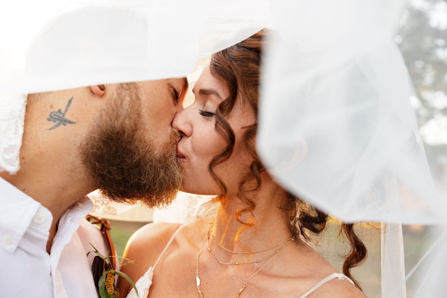 Bride and Groom kiss under her veil for a portrait by Nacogdoches photographer Emily Joy Photography