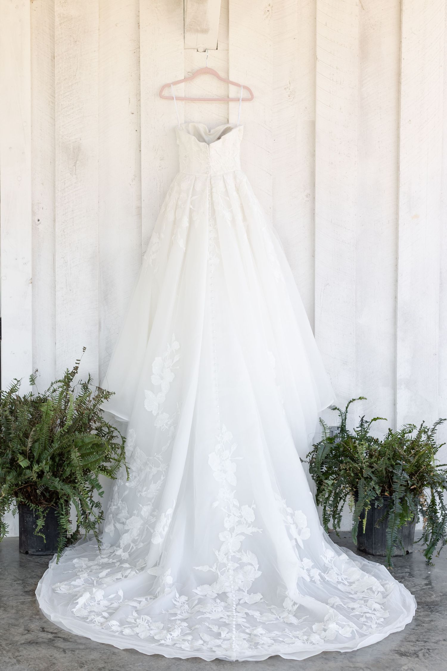 A portrait of a wedding dress and full train with elegant lace. Image by Emily Joy, wedding photographer in Memphis.