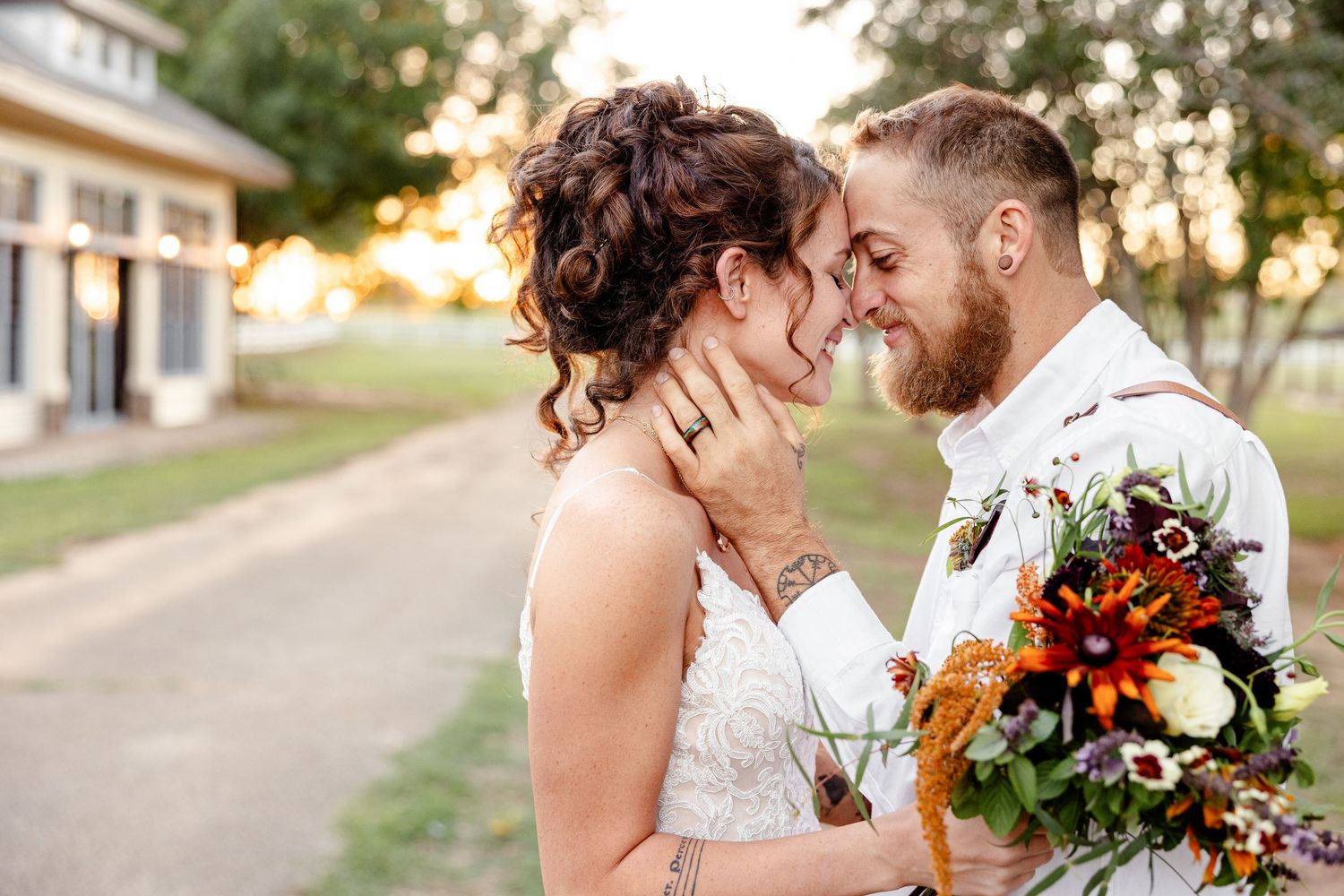 A bride and groom smile as they lean in for a kiss. Image by Emily Joy, wedding photographer in Memphis.
