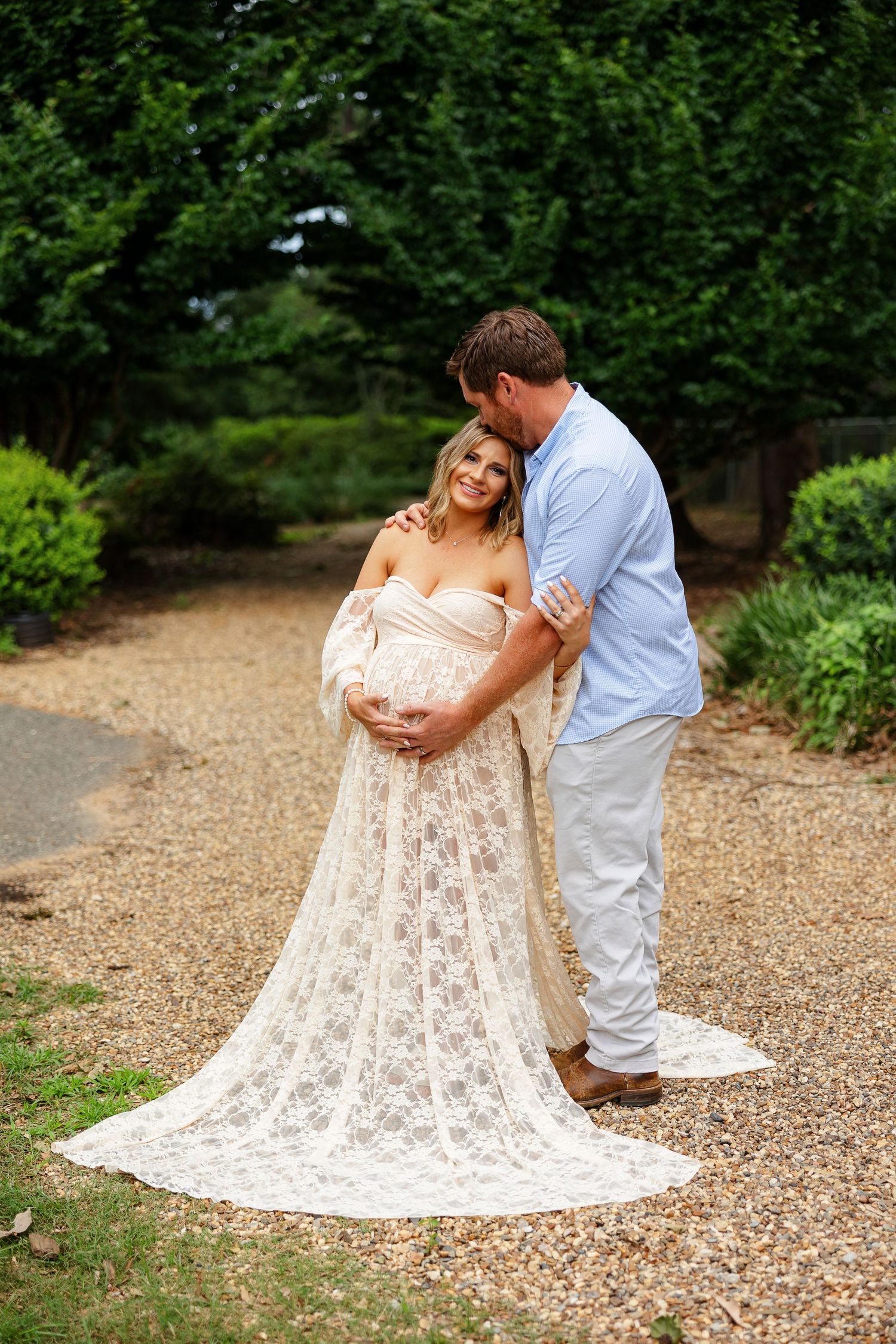Husband kisses his pregnant wife for a portrait by Memphis photographer Emily Joy Photography