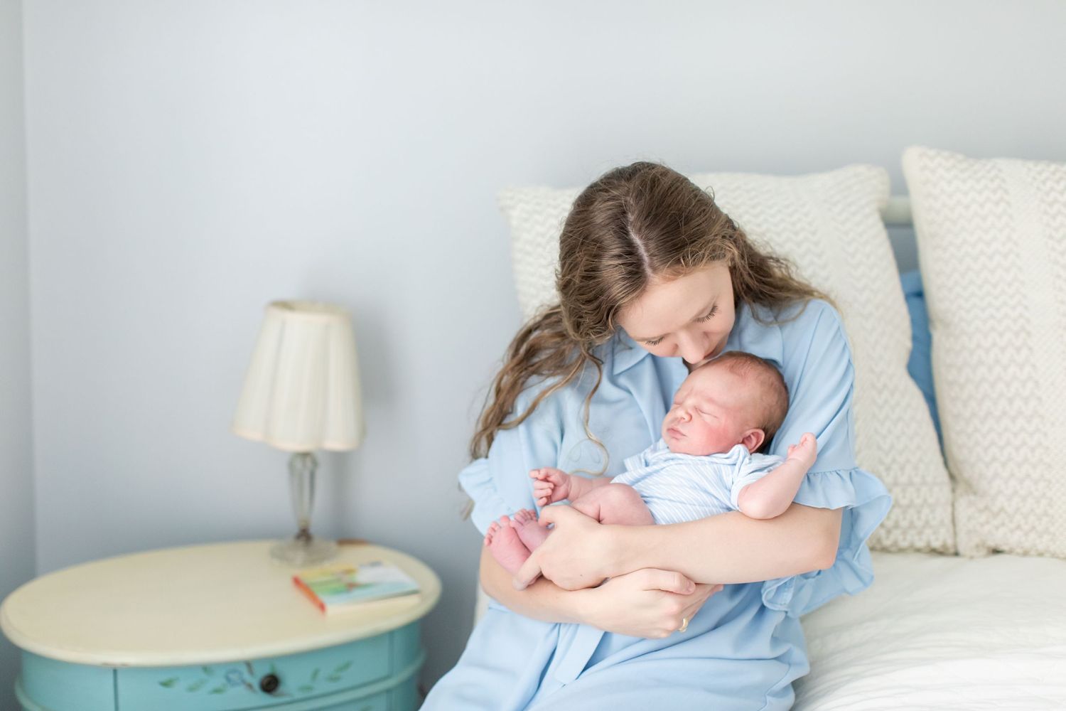 A mother smells her newborn boy for a portrait by Nacogdoches photographer Emily Joy Photography