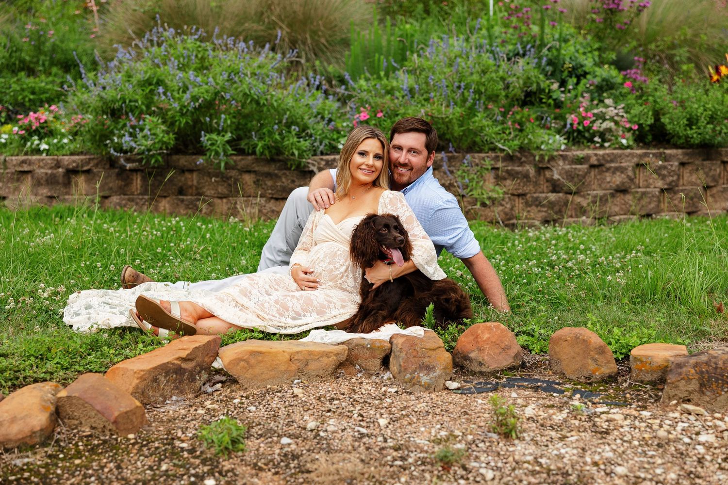 Expectant couple pose with their dog for a portrait by Memphis photographer Emily