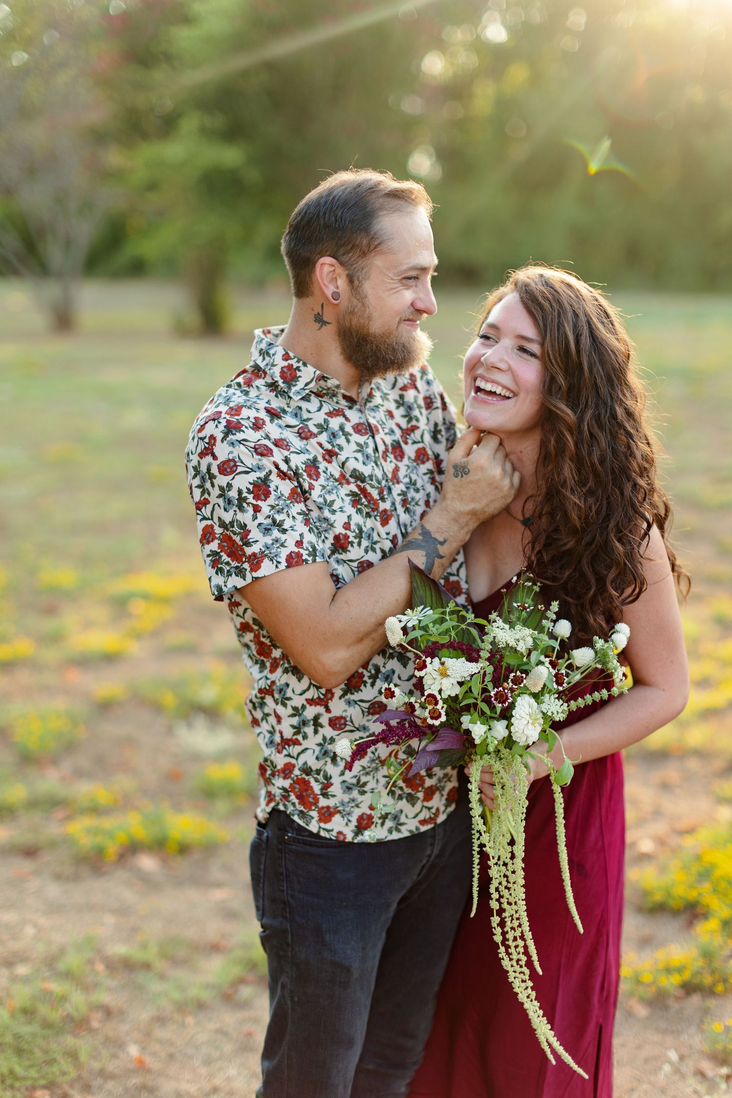 Engaged couple laughs for a portrait  by Emily Joy Photography, now a wedding photographer in Memphis, TN.