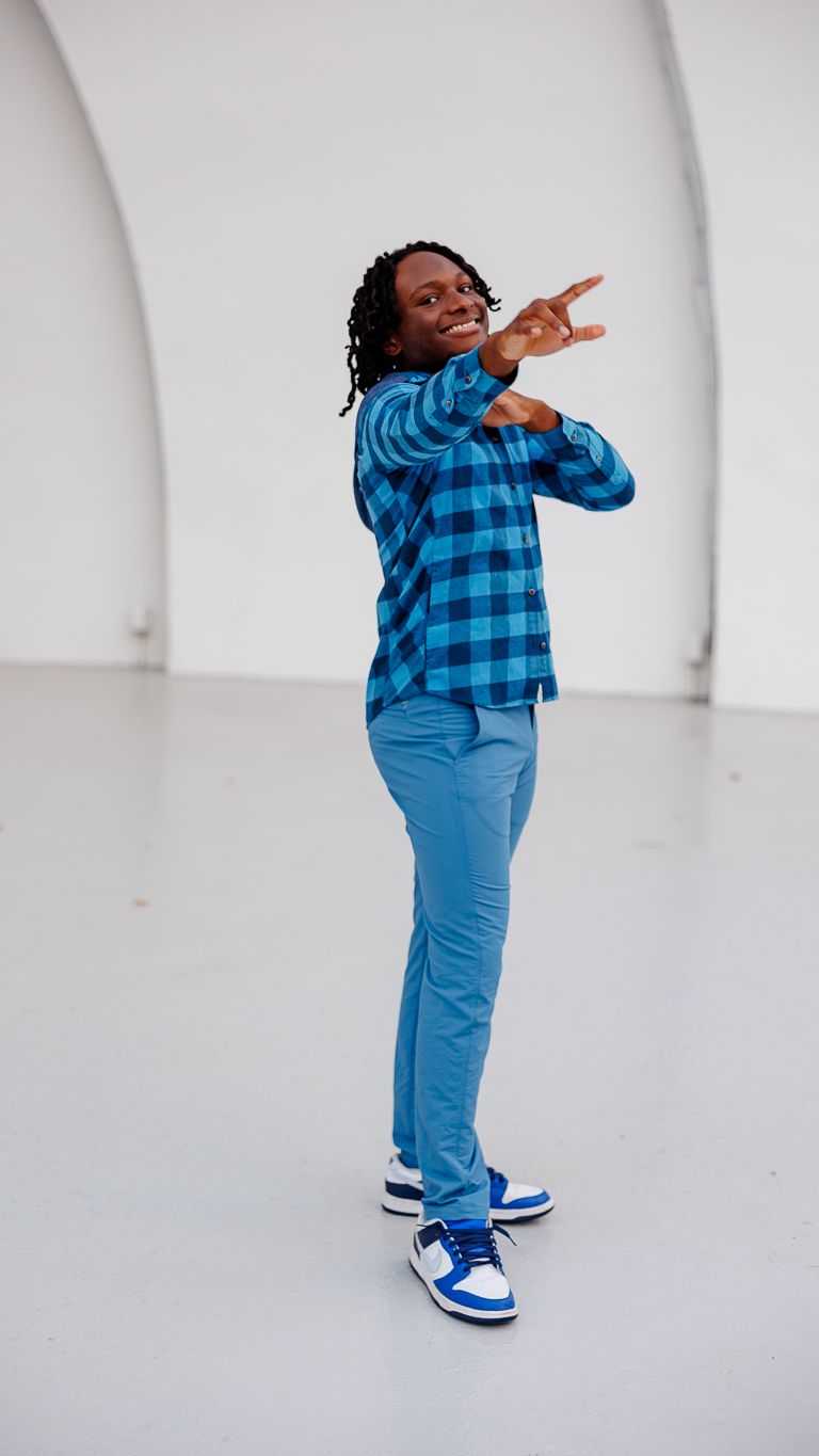 A senior boy poses for a portrait at Overton Park Shell stage.