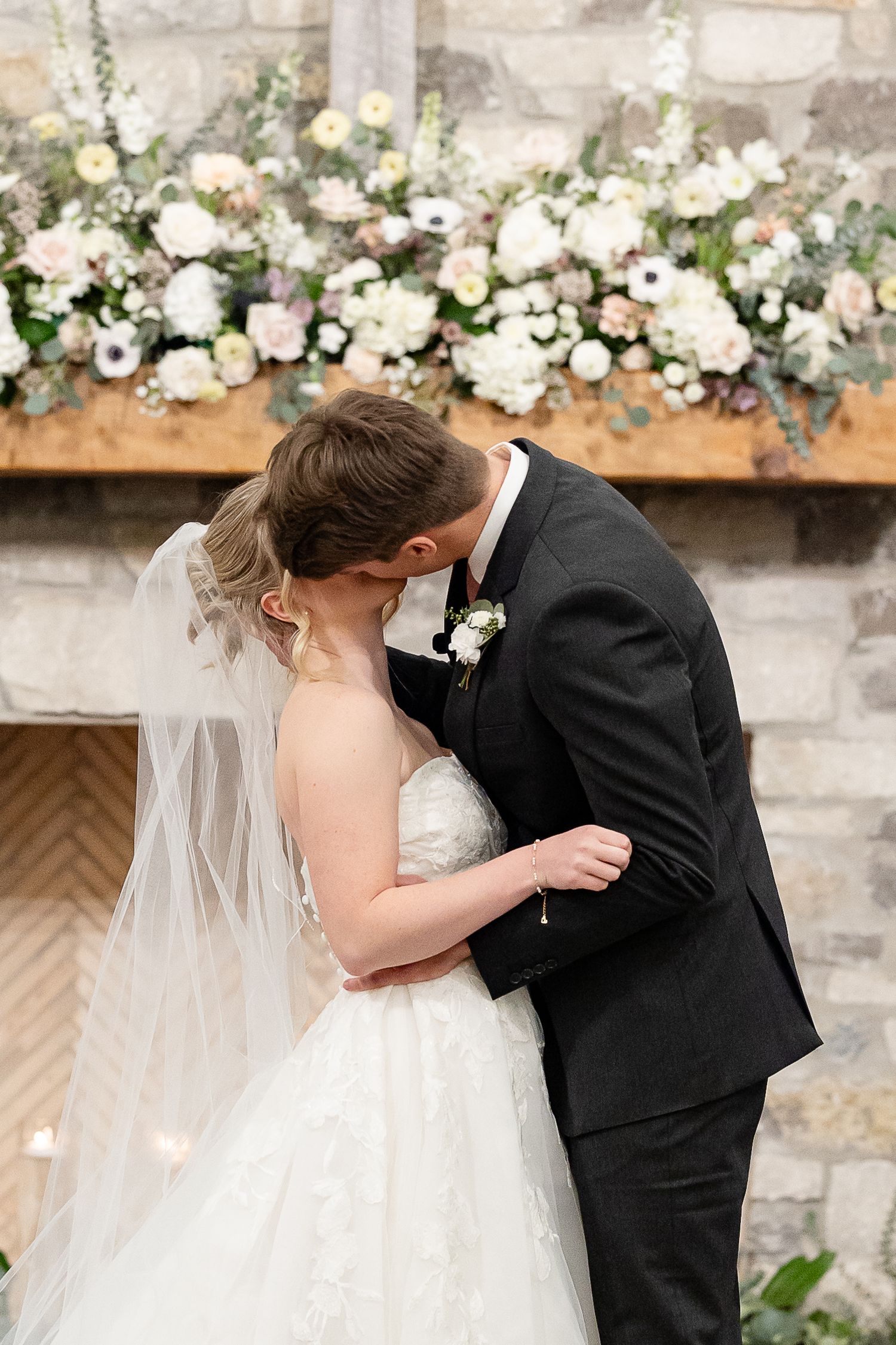 A groom and bride share their first kiss as husband and wife. Image by Emily Joy, wedding photographer in Memphis.