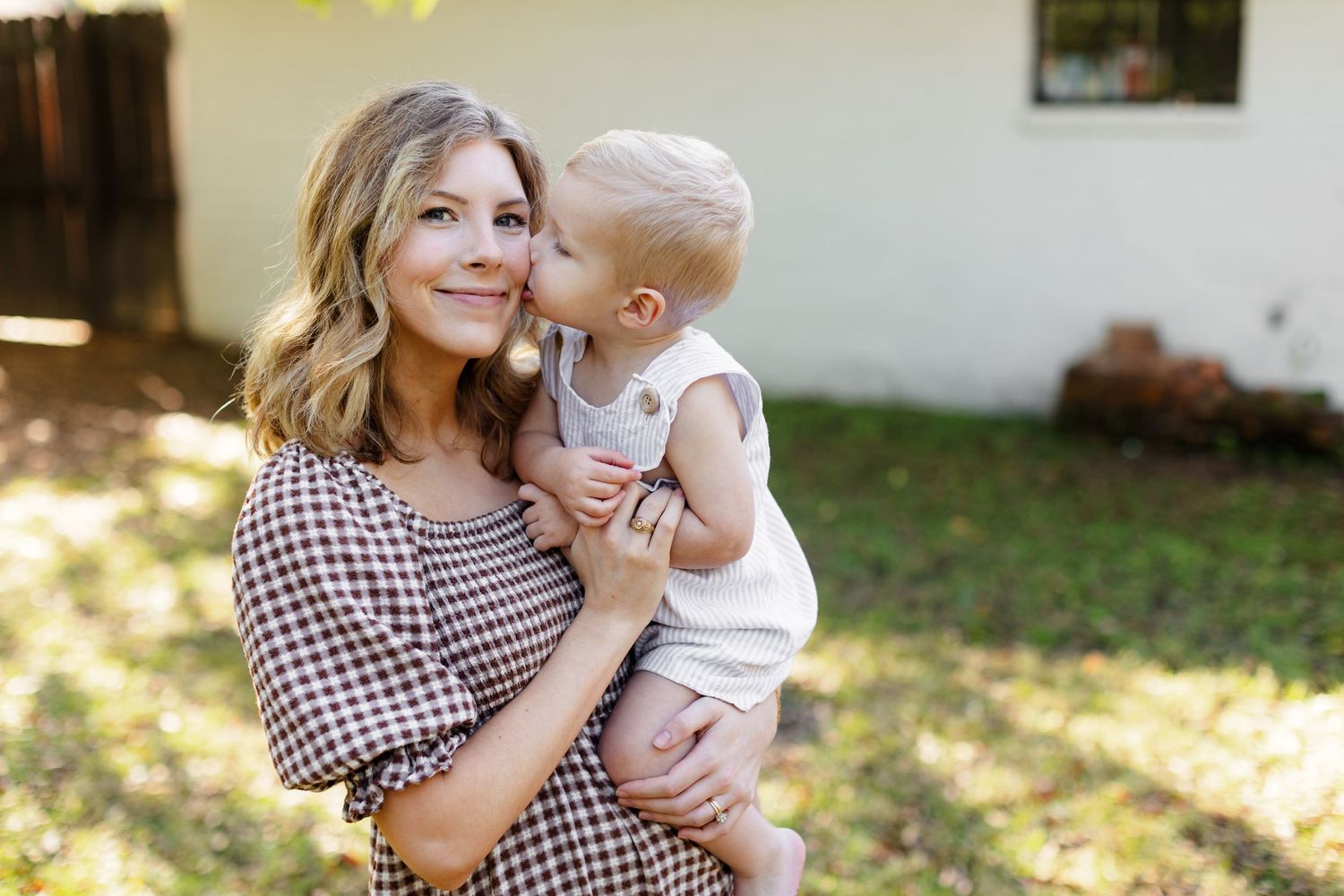 Toddler boy kisses his mama for a portrait by Memphis wedding photographer Emily Joy Photography