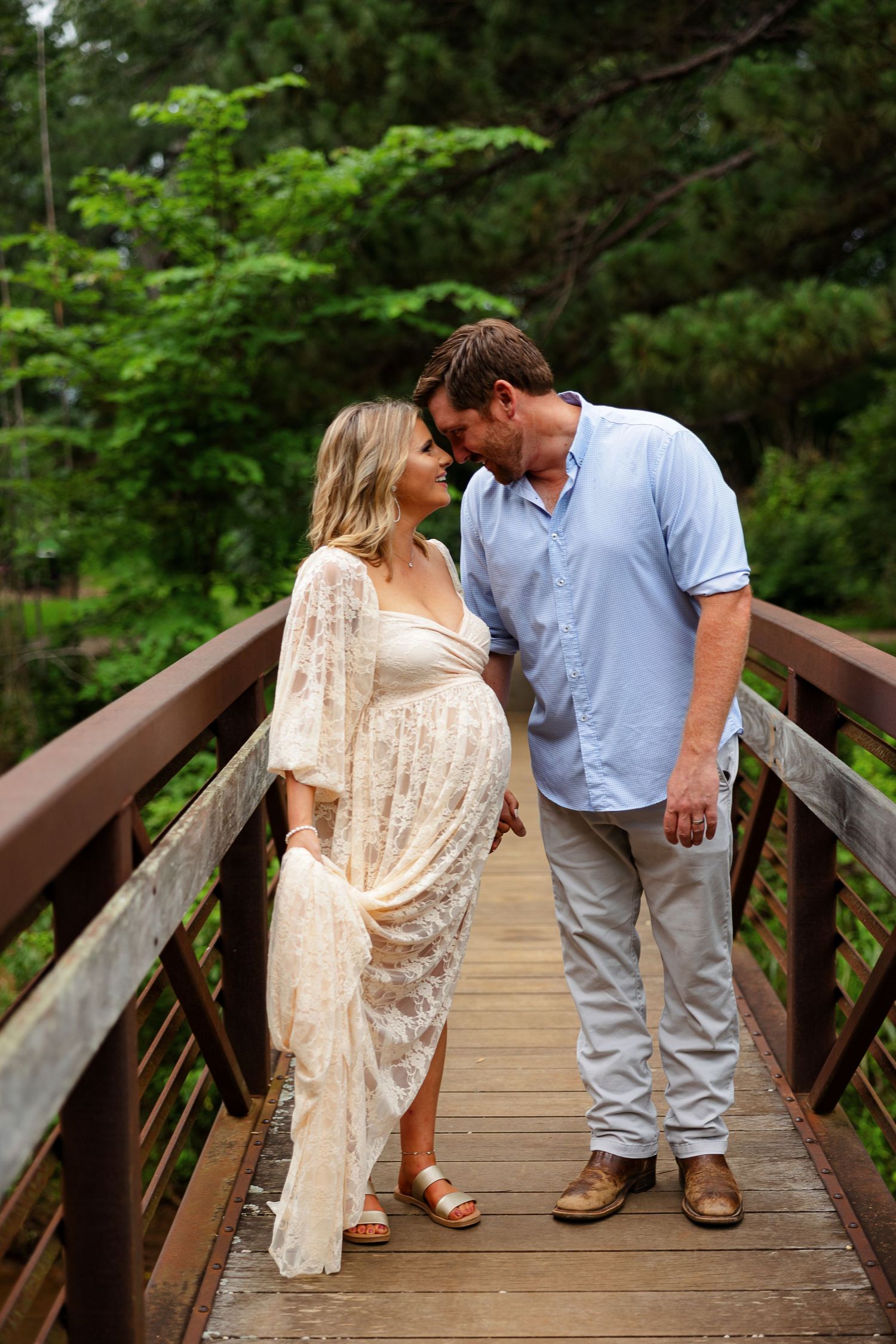 Husband and pregnant wife smile at each other for a portrait by Memphis photographer Emily Joy Photography