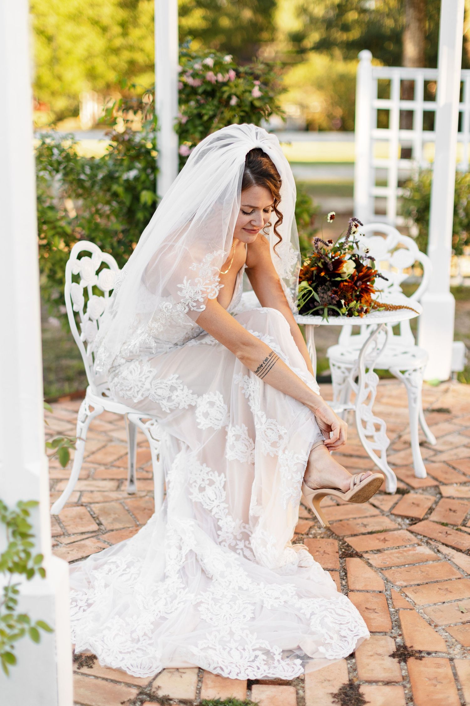 Bride fastening her shoe while preparing for wedding, photographed by Emily Joy Photography, now a wedding photographer in Memphis, TN.