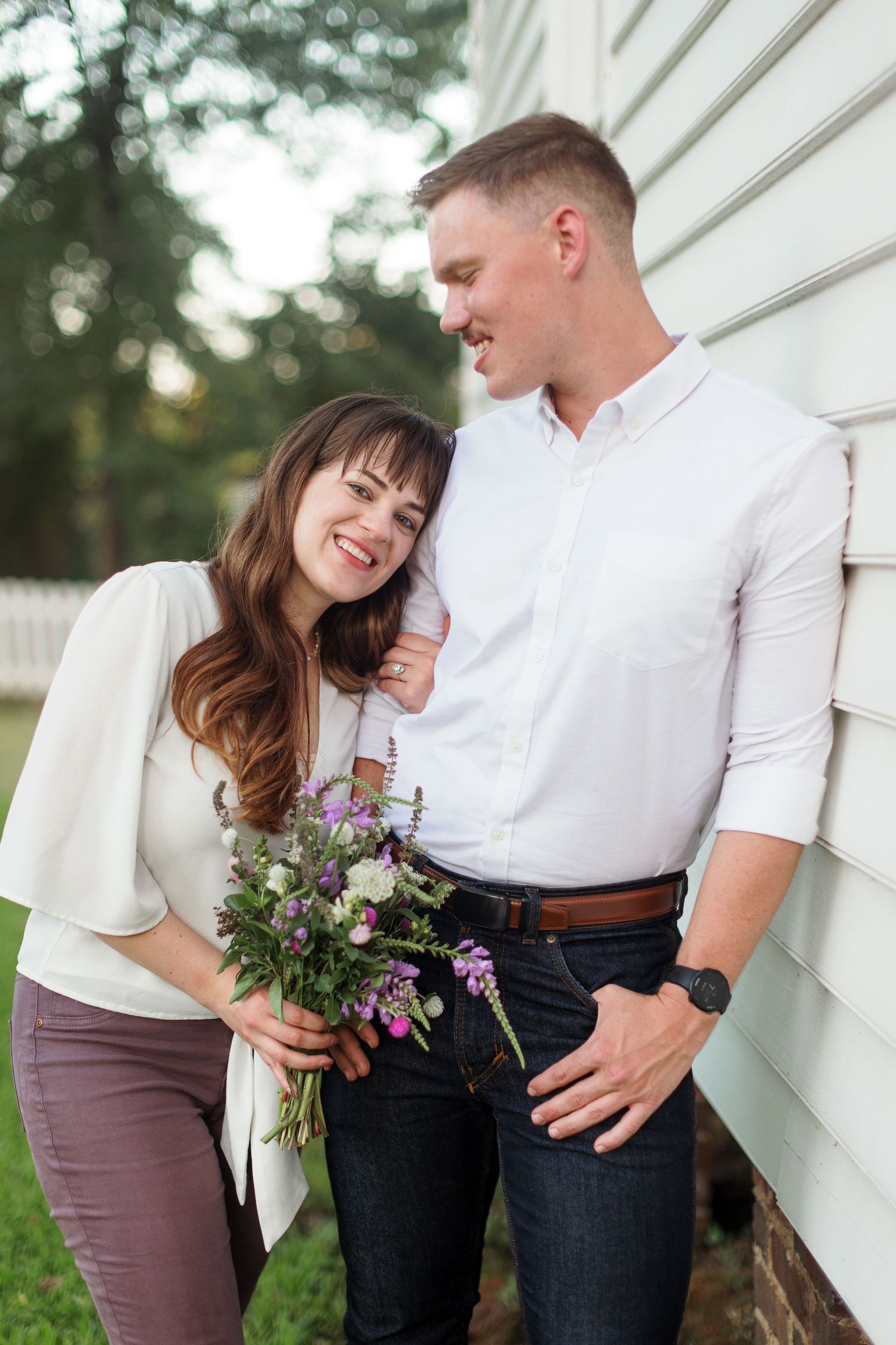 Engaged couple cuddles for a portrait by Emily Joy Photography, now a wedding photographer in Memphis, TN.