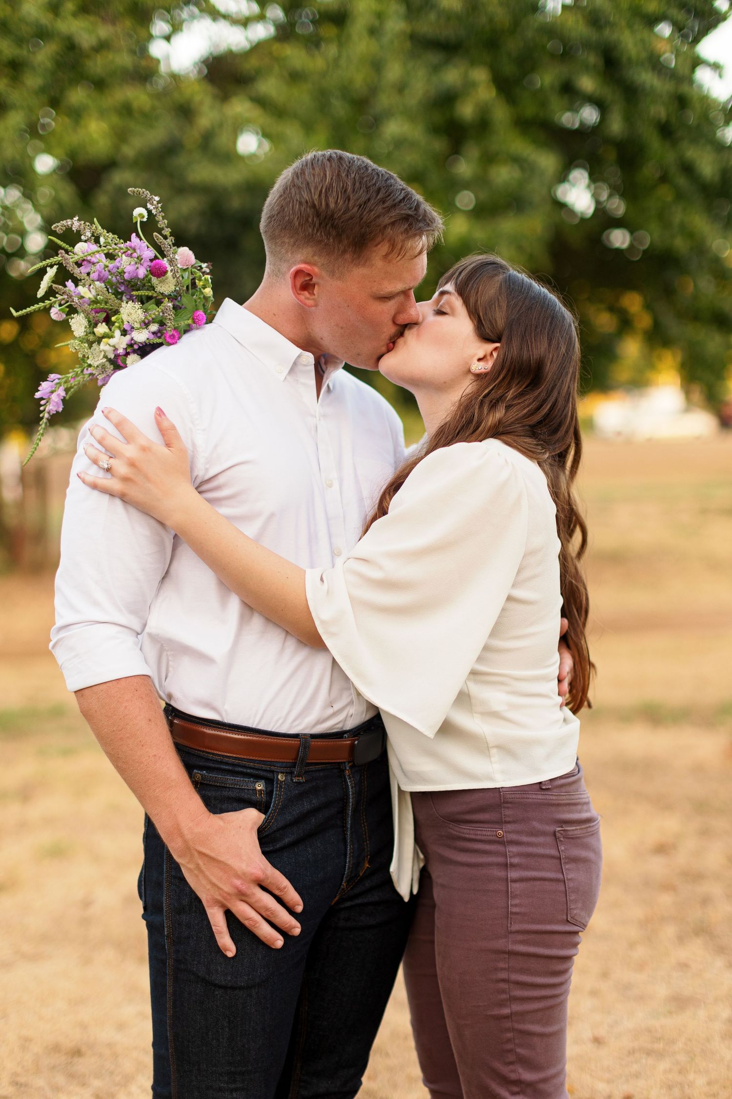 Engaged couple kisses for a portrait by Emily Joy Photography, now a wedding photographer in Memphis, TN.