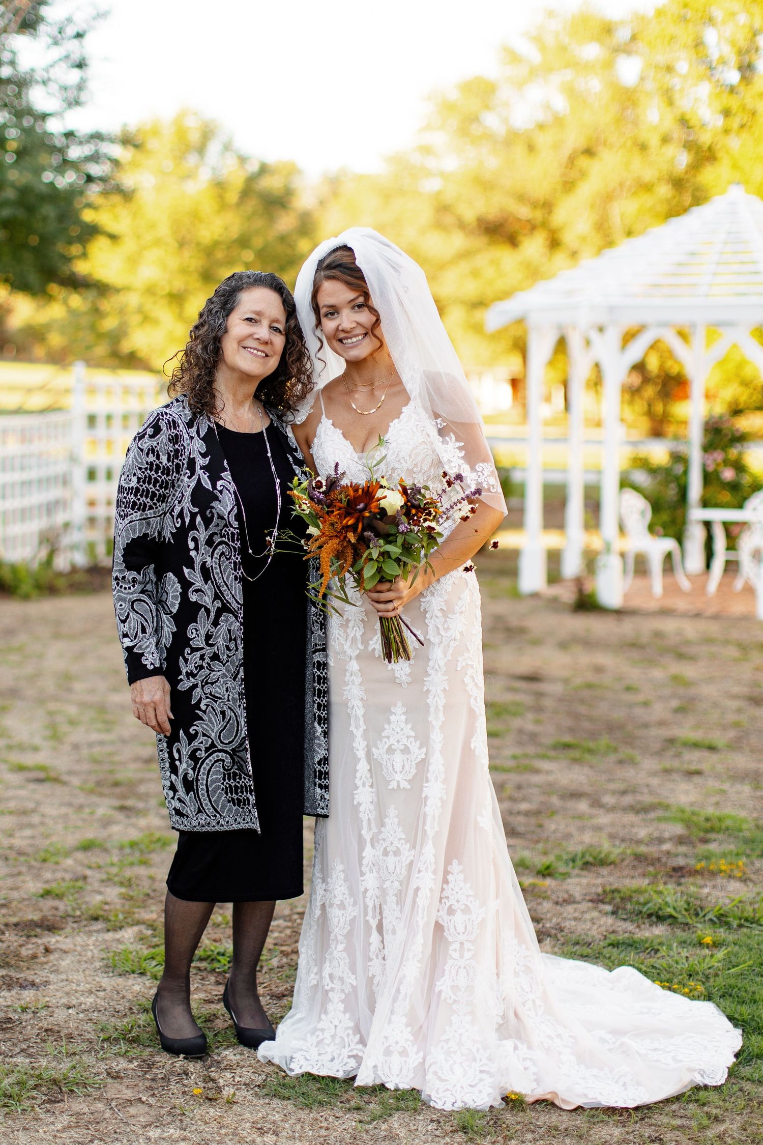 Bride and mother smiling for a portrait photographed by Emily Joy Photography, now a wedding photographer in Memphis, TN.