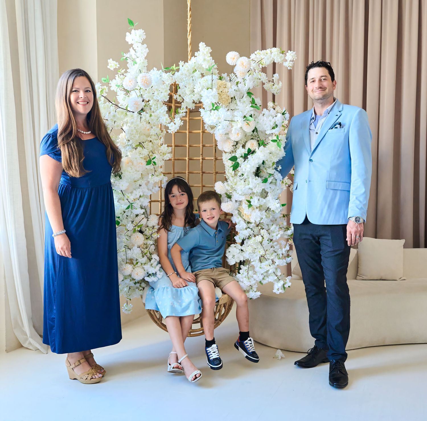 Family of four posing together during a Toronto studio family photography session.
