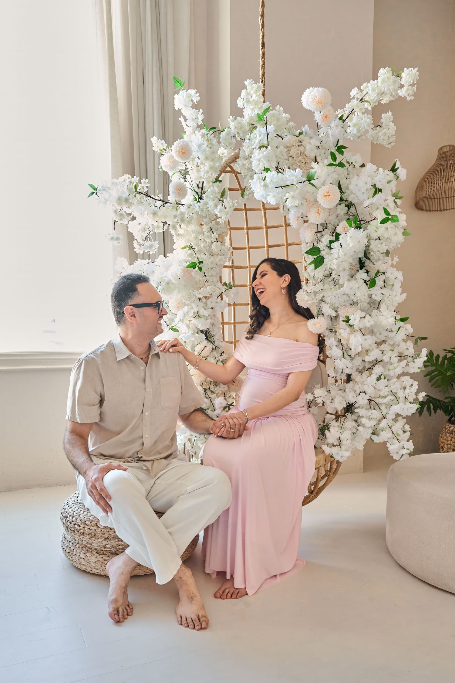Expecting parents laughing together during a natural Toronto maternity photography session.