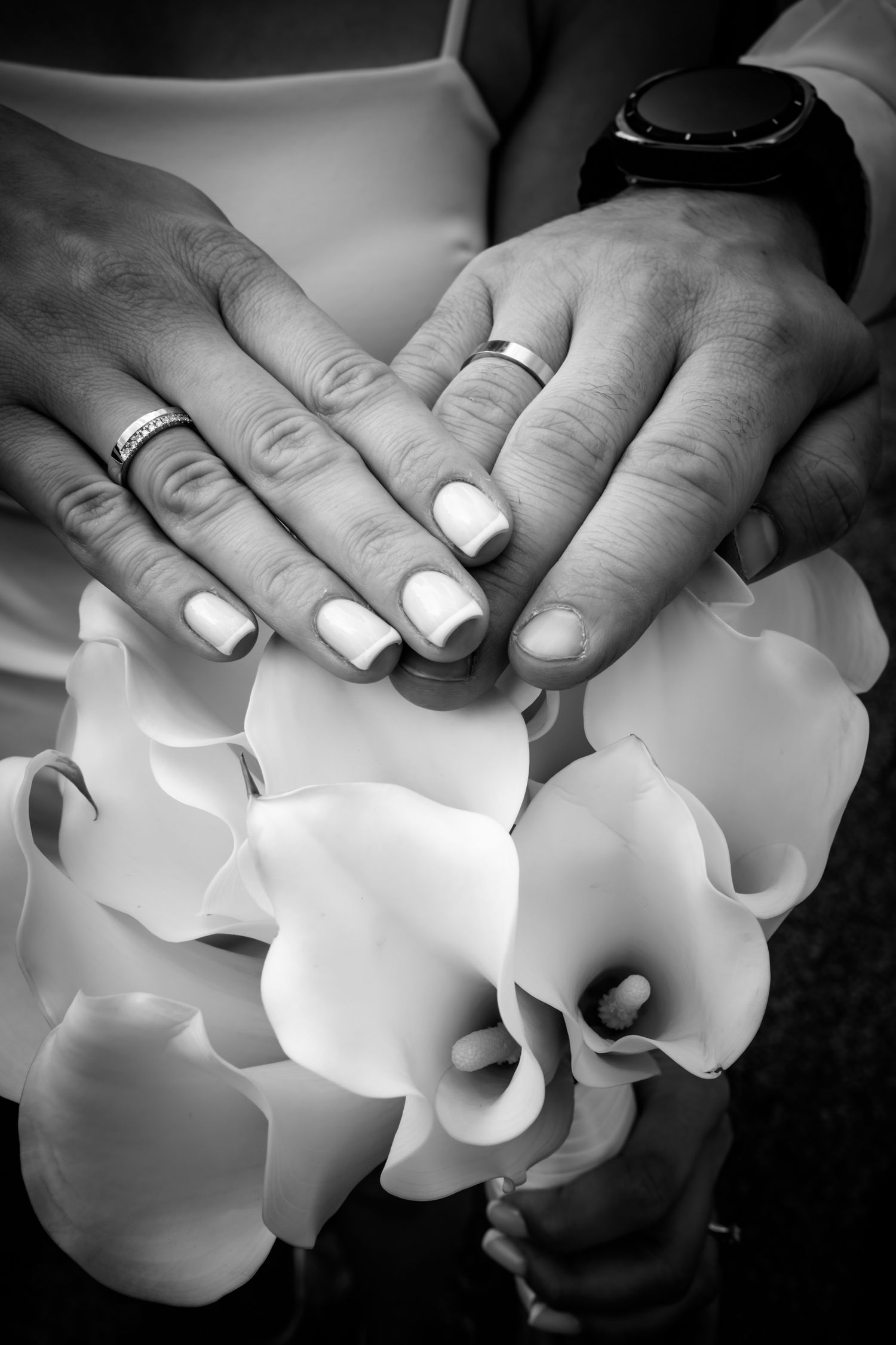 Close-up of wedding rings resting above a white bridal bouquet during a Toronto wedding.