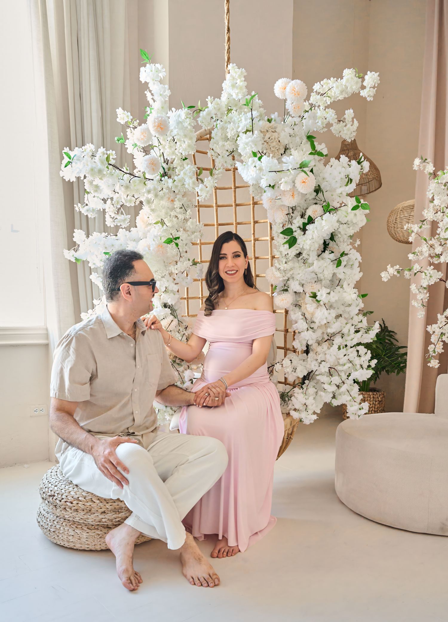 Expecting couple sitting together during a relaxed Toronto maternity photography session.