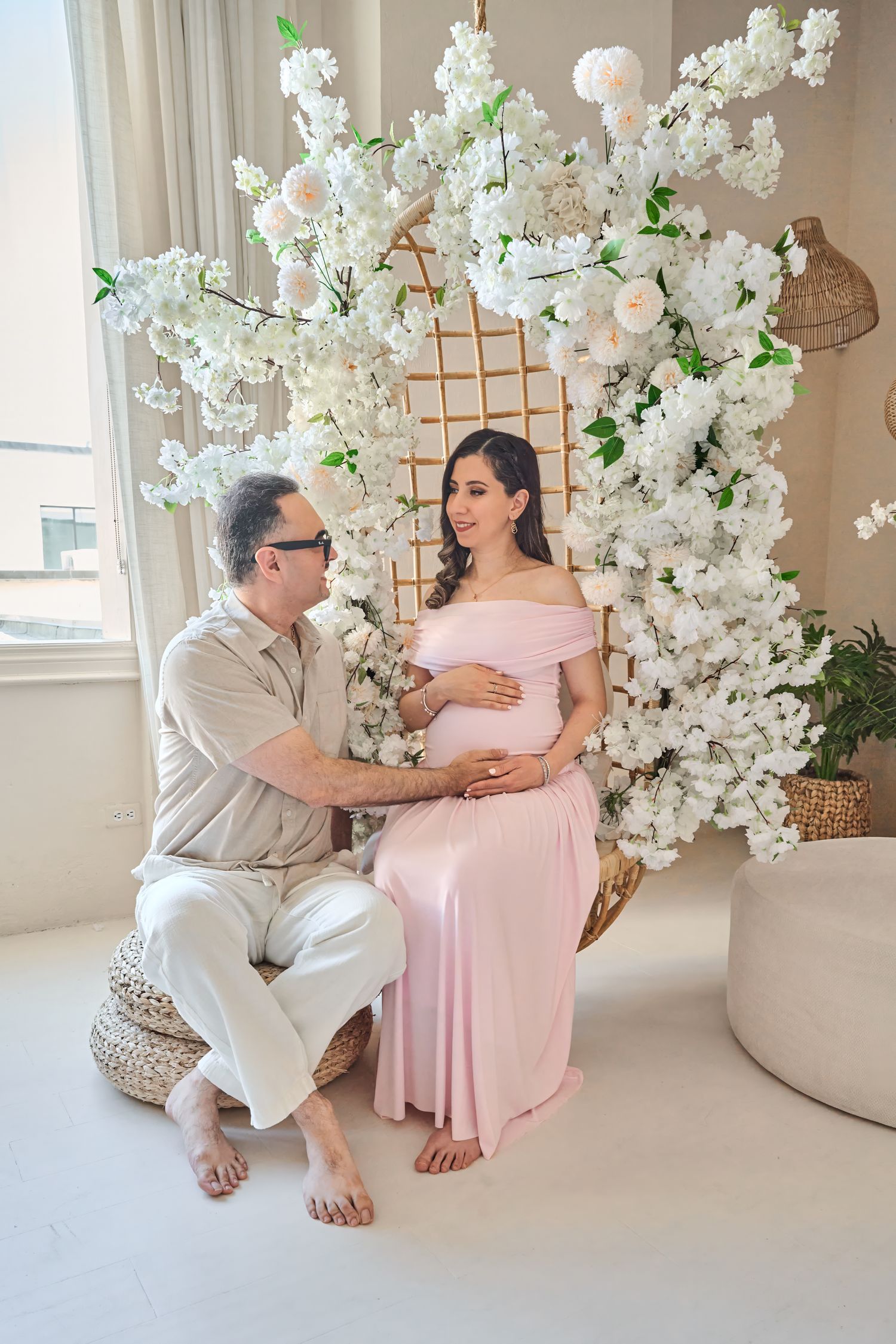 Expecting couple photographed together during a Toronto maternity photography session in a floral studio.