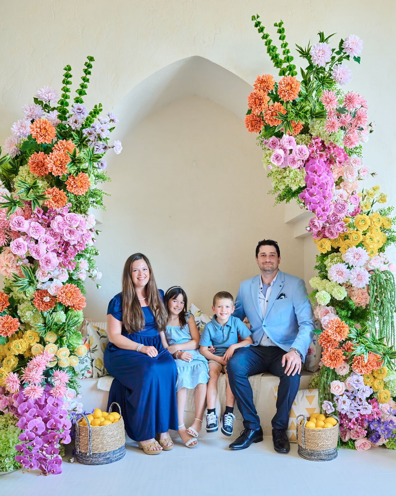 Family of four photographed together in a colourful Toronto studio setting.