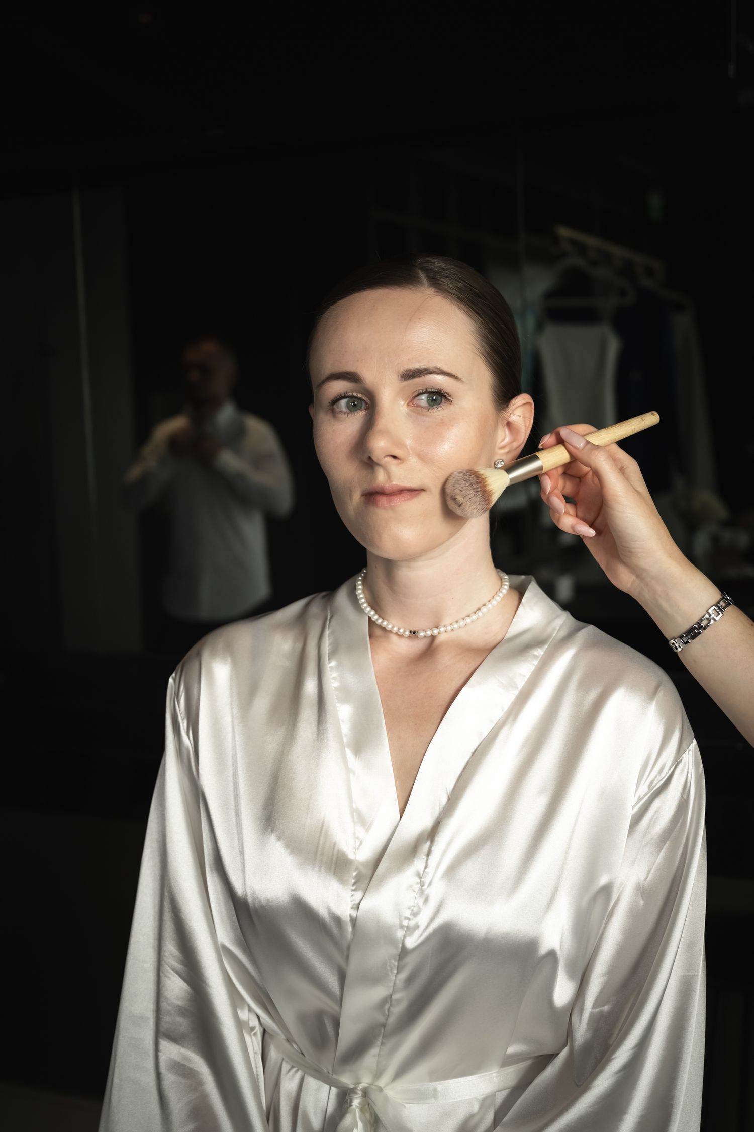 Bride having her makeup applied while getting ready for a Toronto wedding.