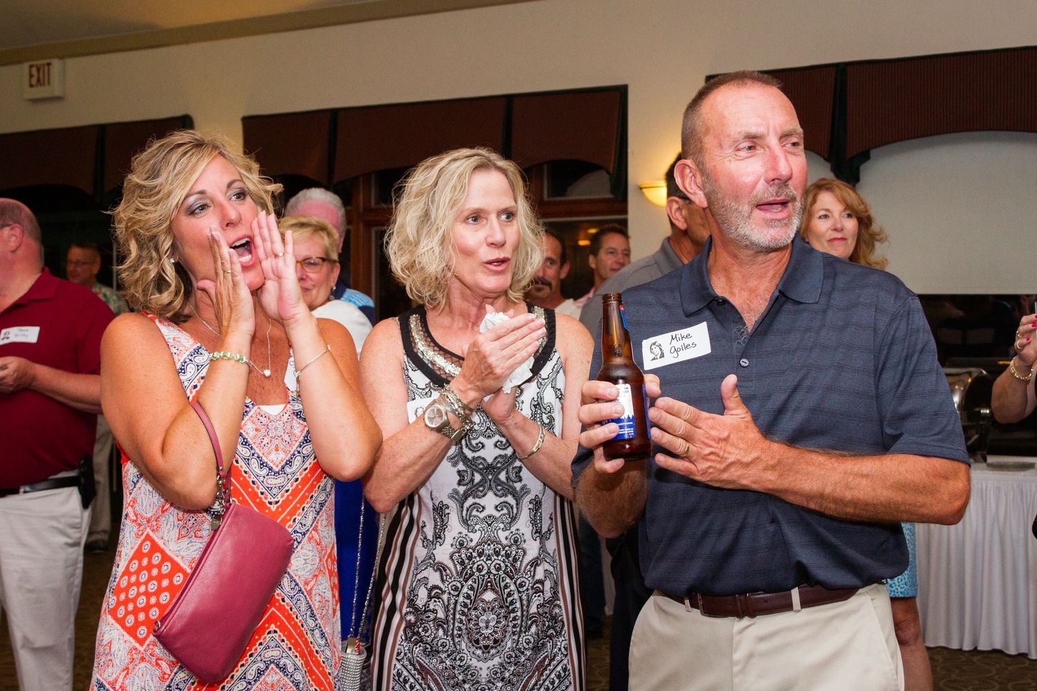 People enjoying themselves at a festive indoor celebration with animated expressions.