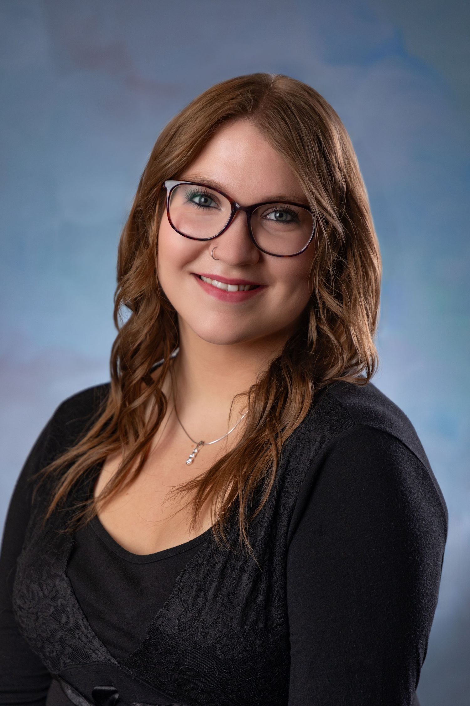 Professional portrait sequence showing someone in black outfit against blue studio background.
