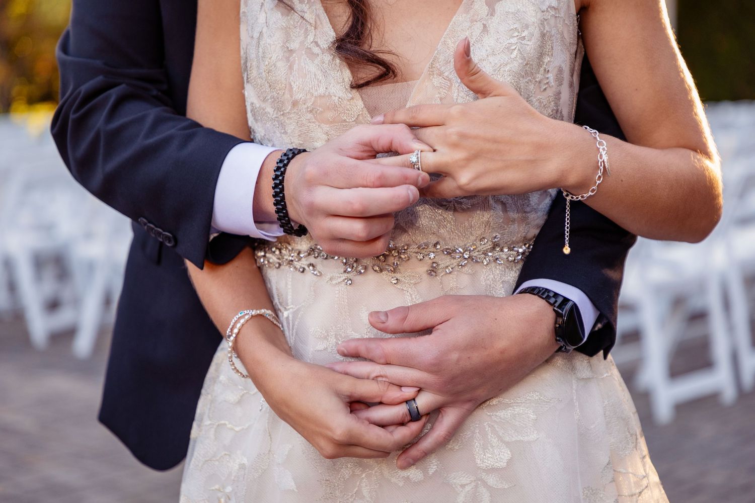 Detail shots of wedding rings and hands during outdoor photo session.