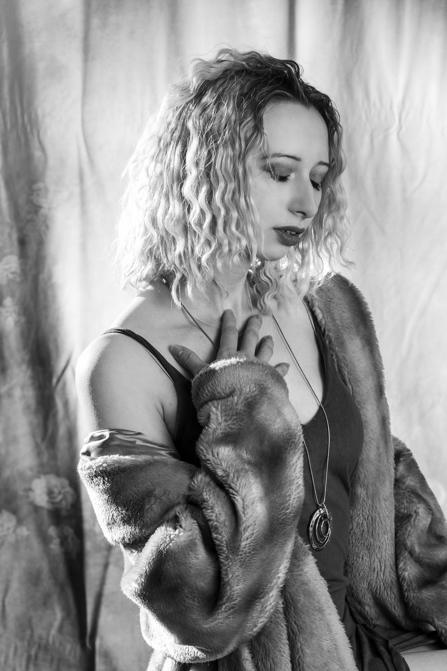 Artistic black and white portrait series showing intimate romantic poses against a textured backdrop.