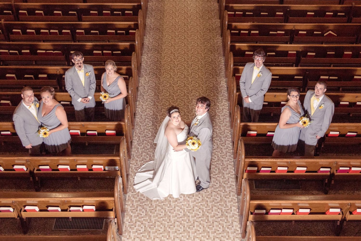 Wedding ceremony photos in a church with wooden pews and decorative wallpaper.
