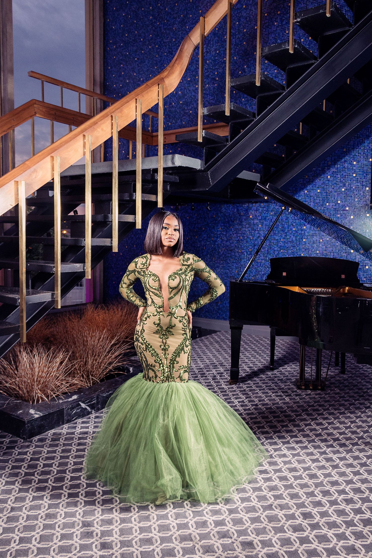 Elegant green tulle ballgown photographed against starry backdrop with dramatic lighting.