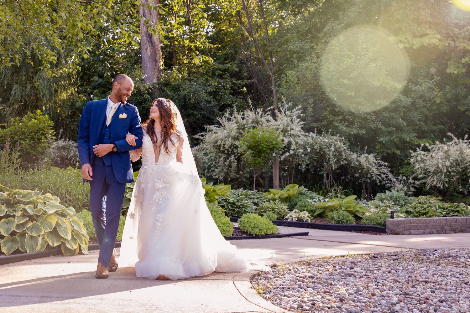 A bride and groom share an intimate moment in a lush garden setting.