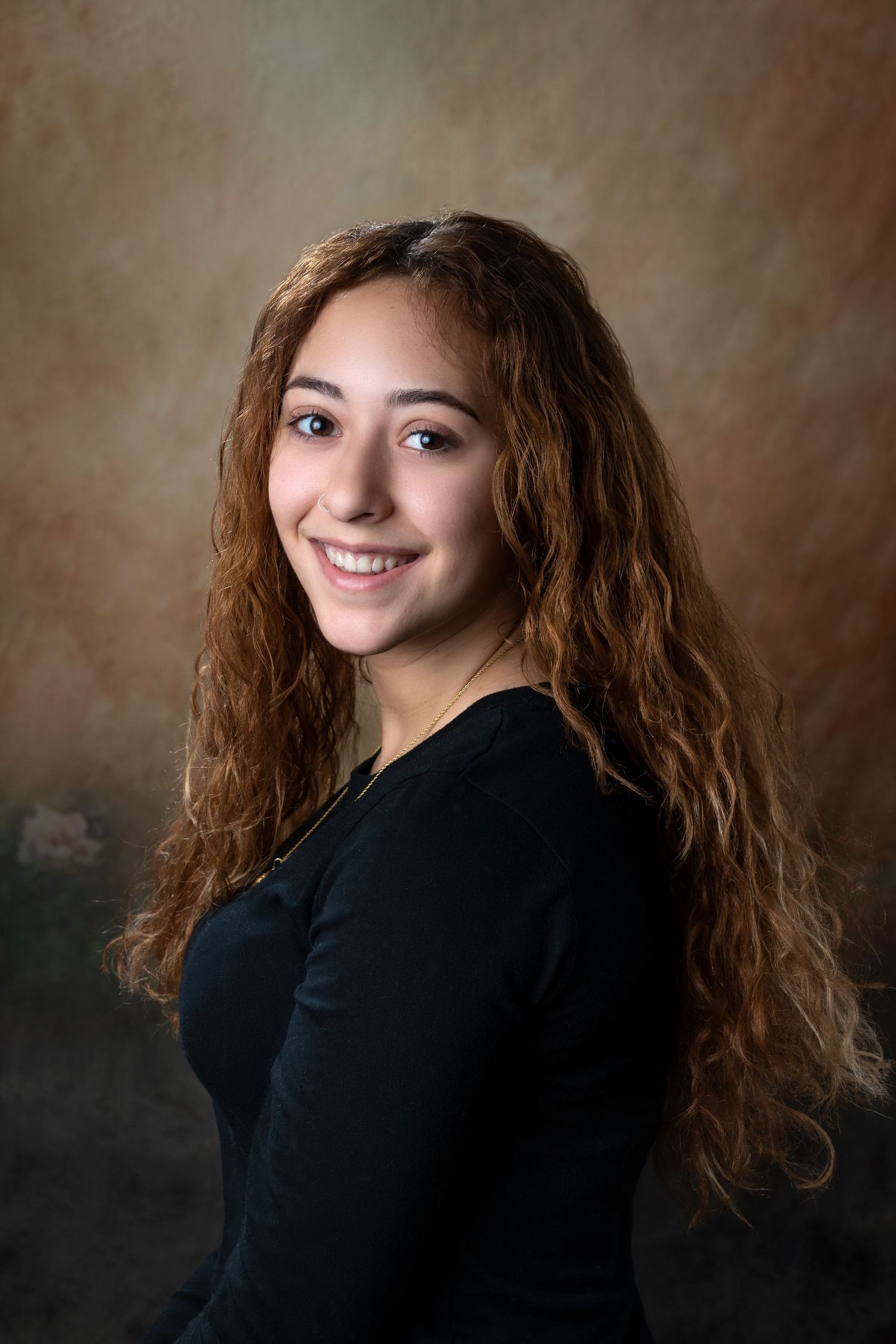 Portrait sequence showing natural poses in black top against textured brown background.