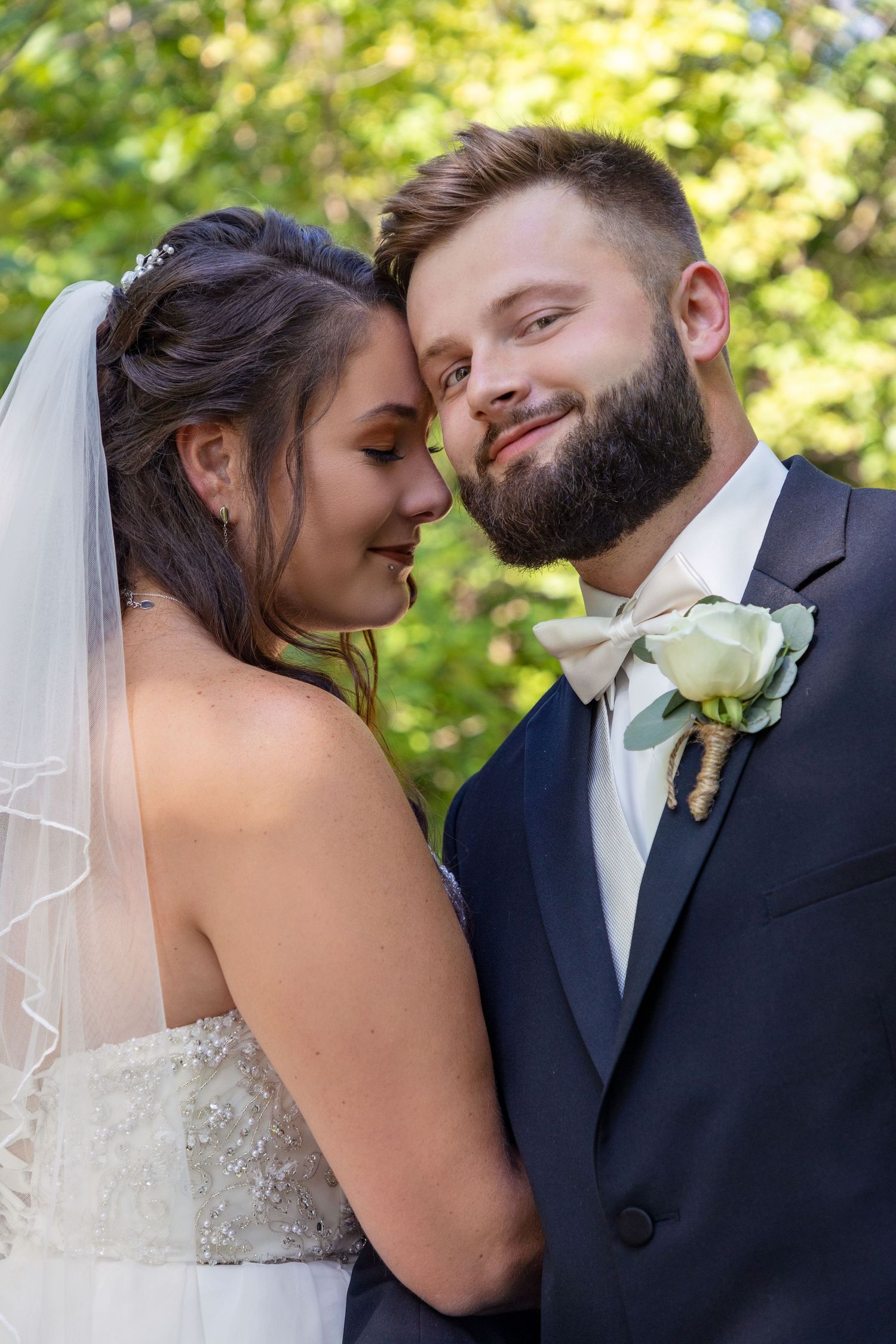 Romantic wedding portrait sequence with couple in formal attire against natural background.