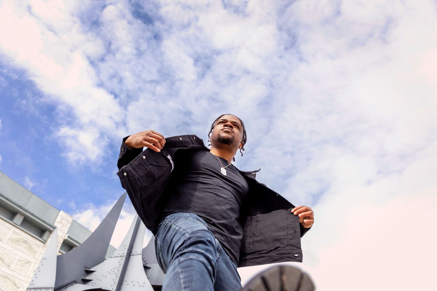 Low angle shots of people against blue cloudy sky.