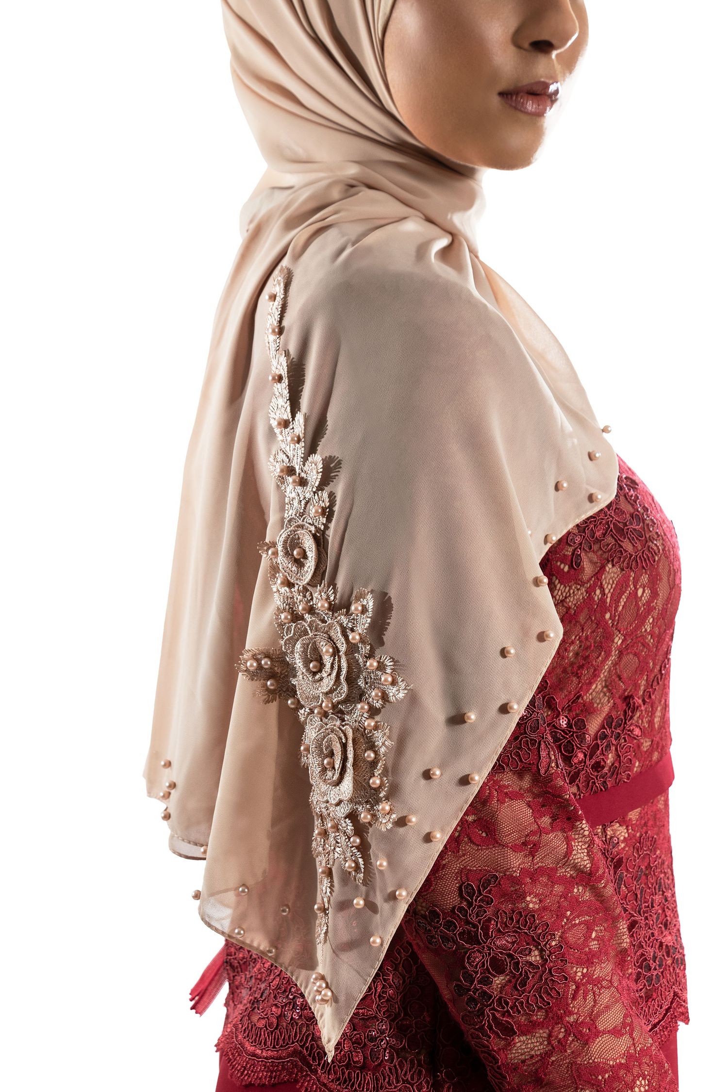 Beige hijab with pearl embellishments paired with a deep red lace dress.